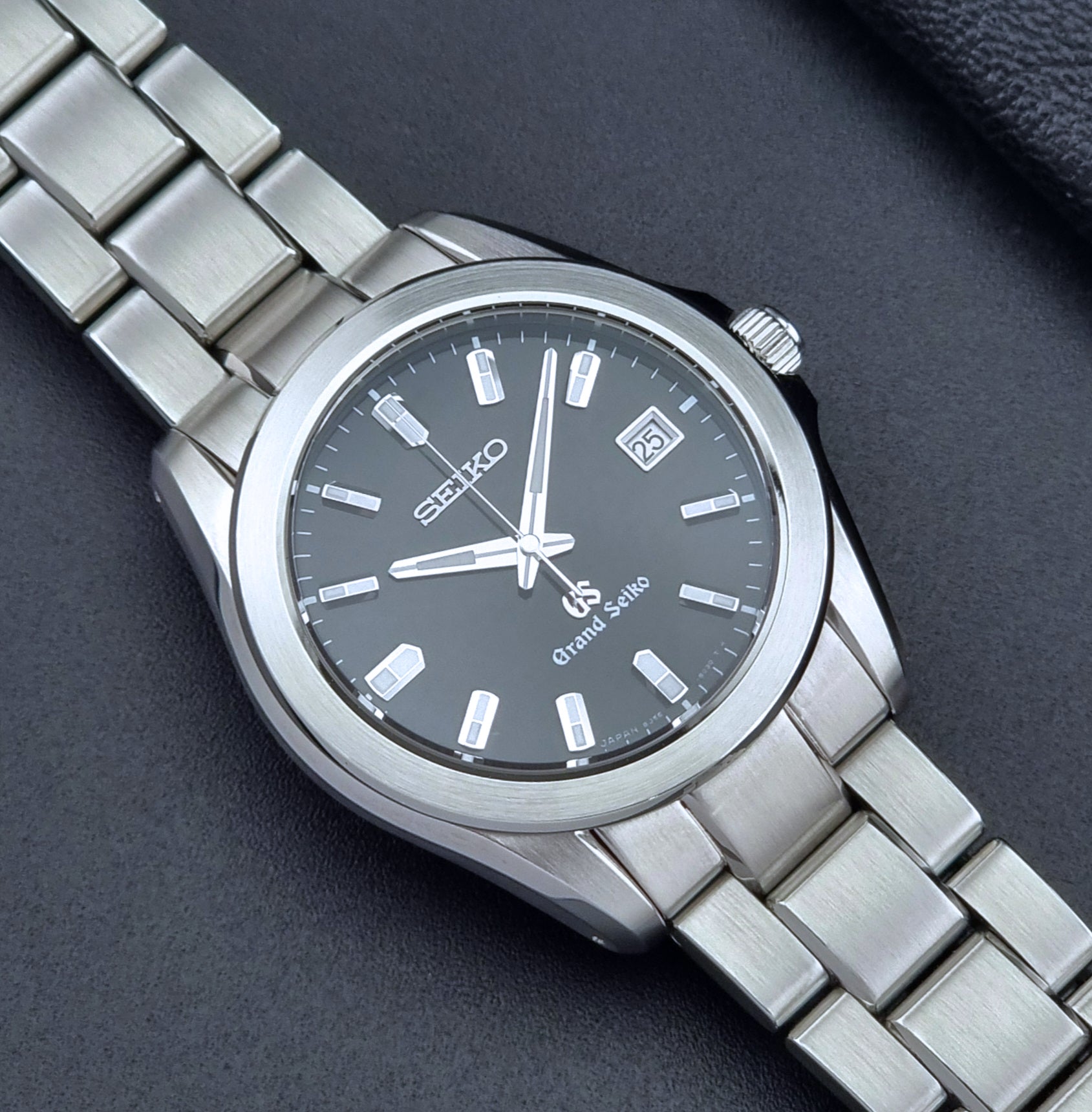 Grand Seiko quartz watch 8J56-8020 with a dark face on a dark background close up dial view