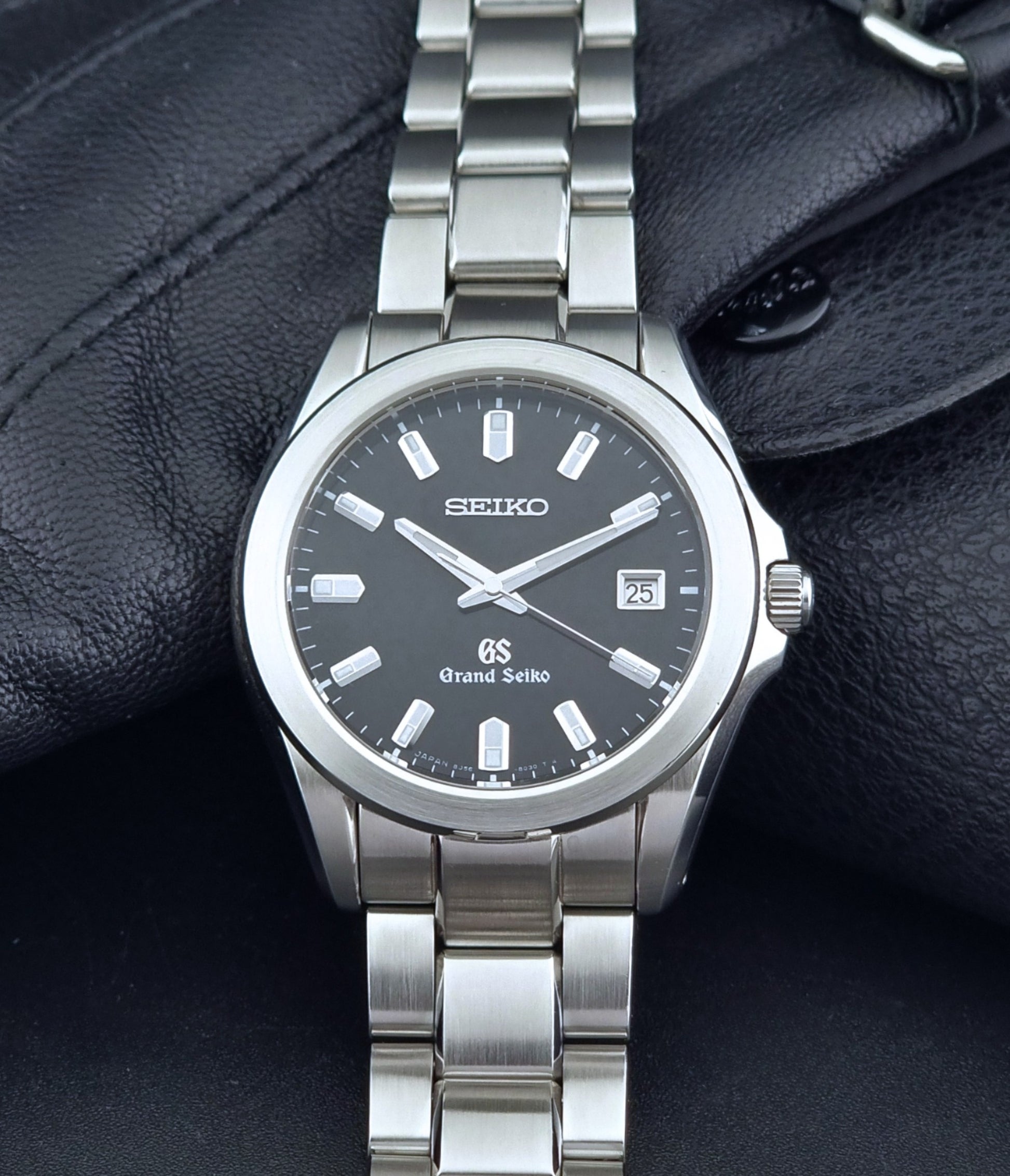 Grand Seiko quartz watch 8J56-8020 with a dark face on a dark background dial view