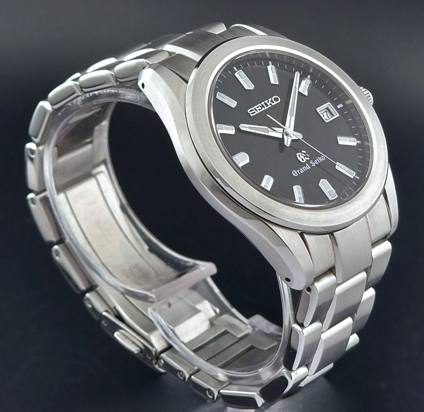 Grand Seiko quartz watch 8J56-8020 with a dark face on a dark background side profile view