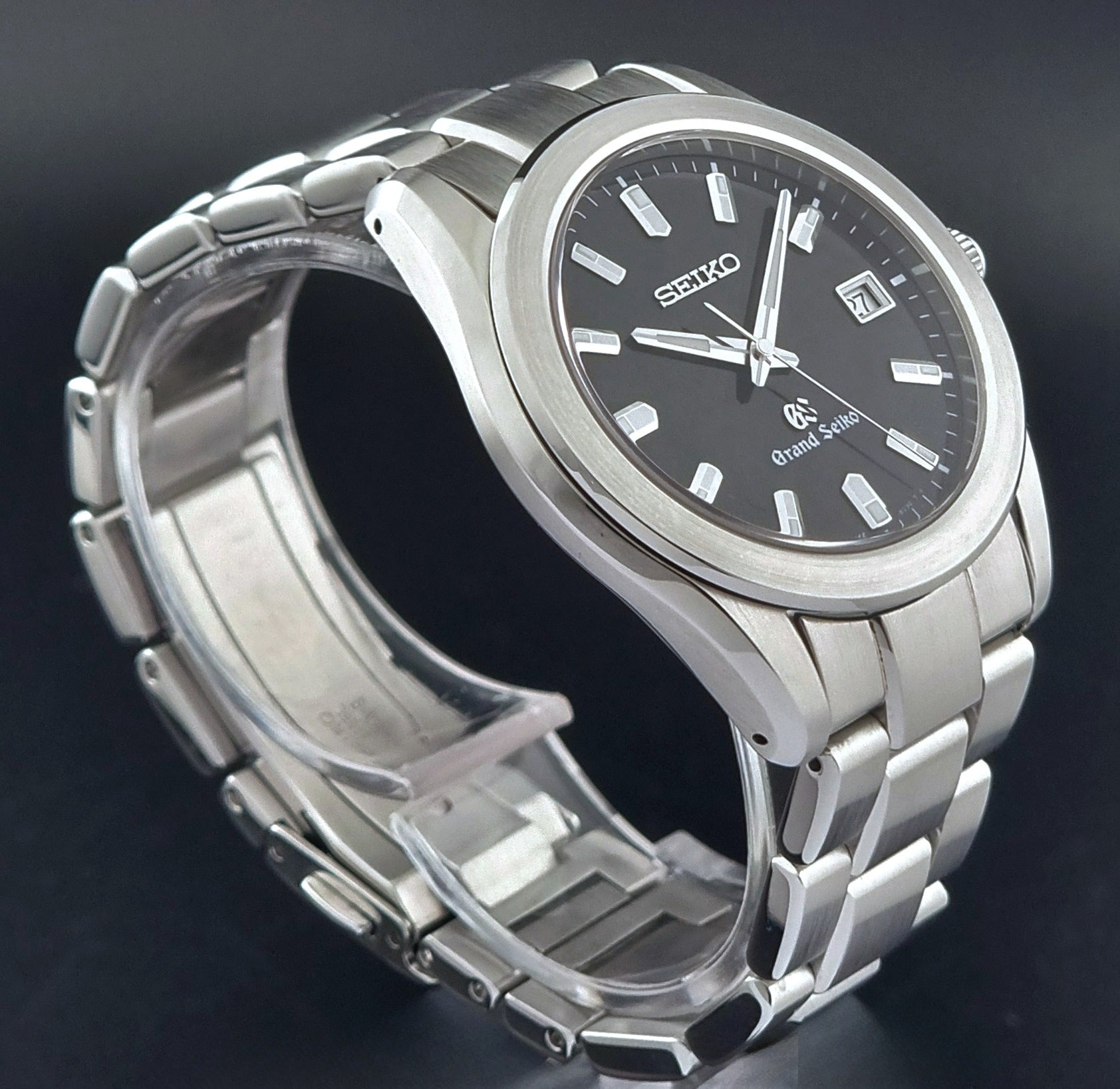 Grand Seiko quartz watch 8J56-8020 with a dark face on a dark background side profile view