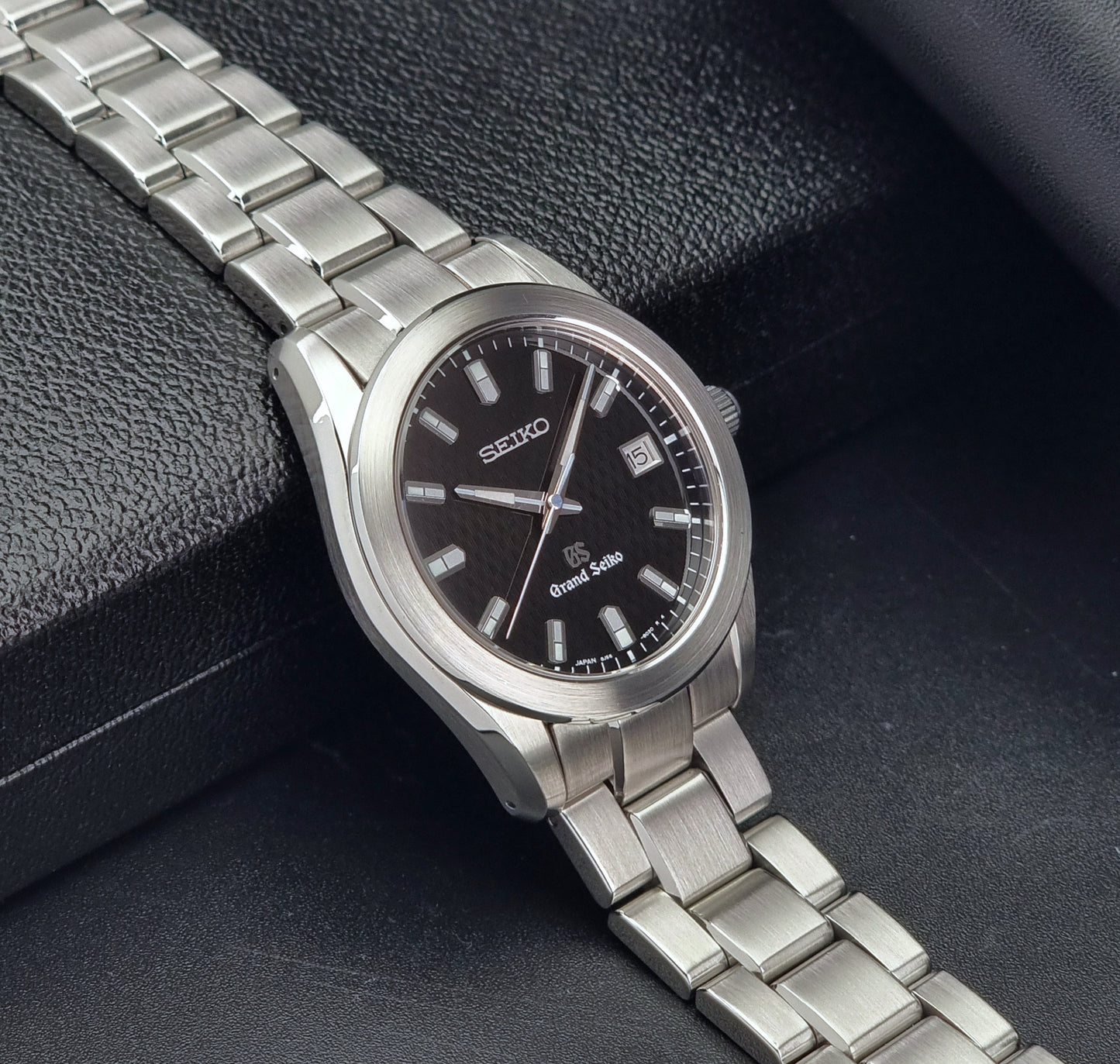 Grand Seiko SBGF021 quartz 8J56-8020 watch with a dark face on a dark background side view