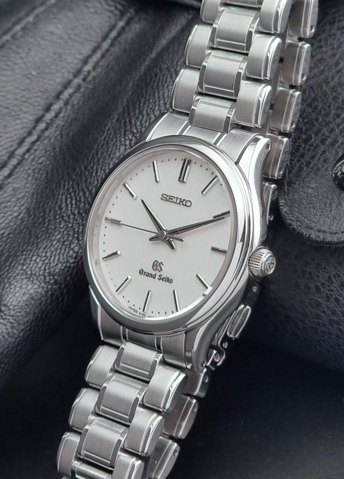 Grand Seiko SBGF027 quartz watch 8J55-0AA0 watch on a dark textured background crown view