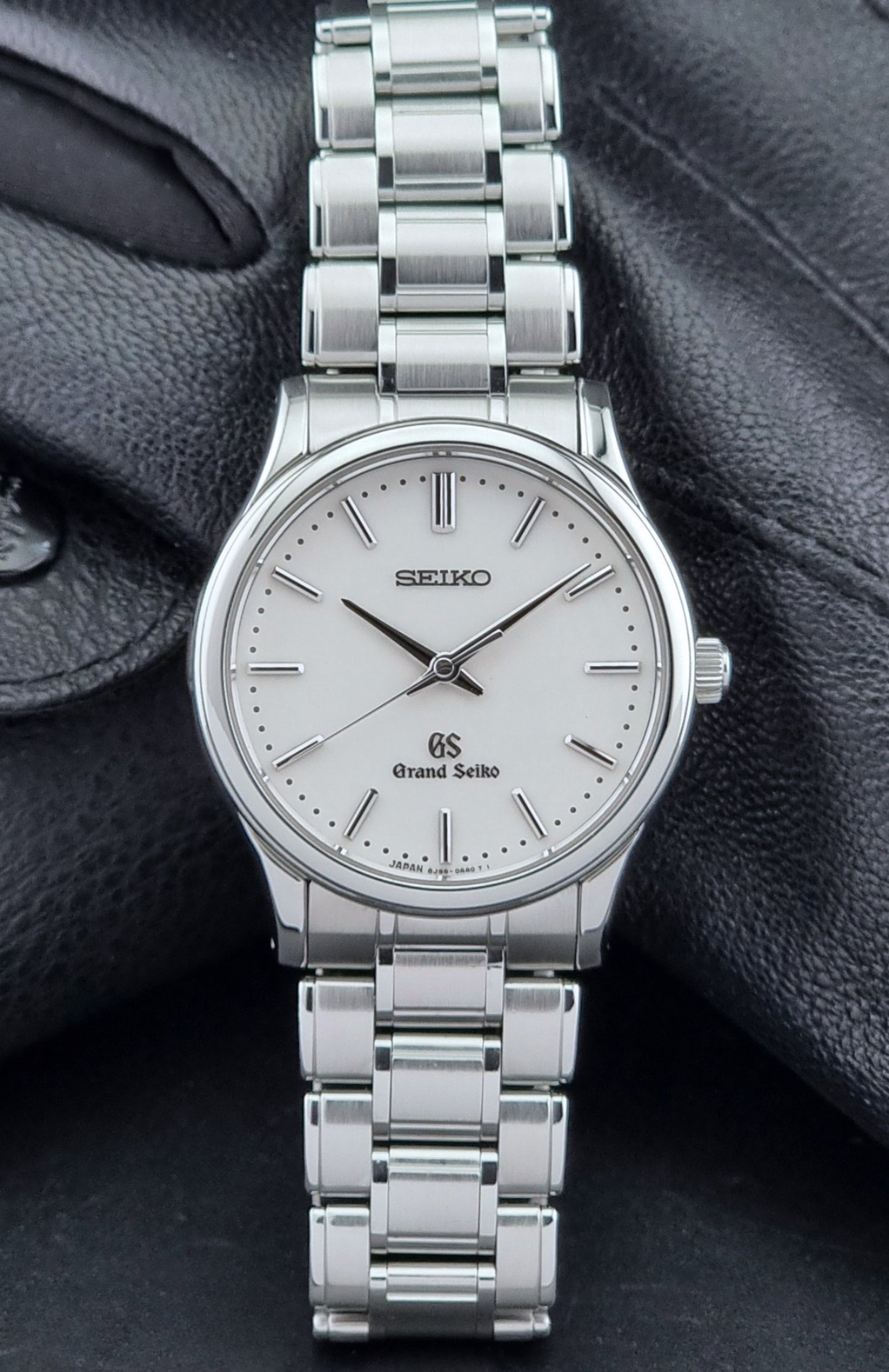 Grand Seiko SBGF027 quartz watch 8J55-0AA0 watch on a dark textured background close dial view