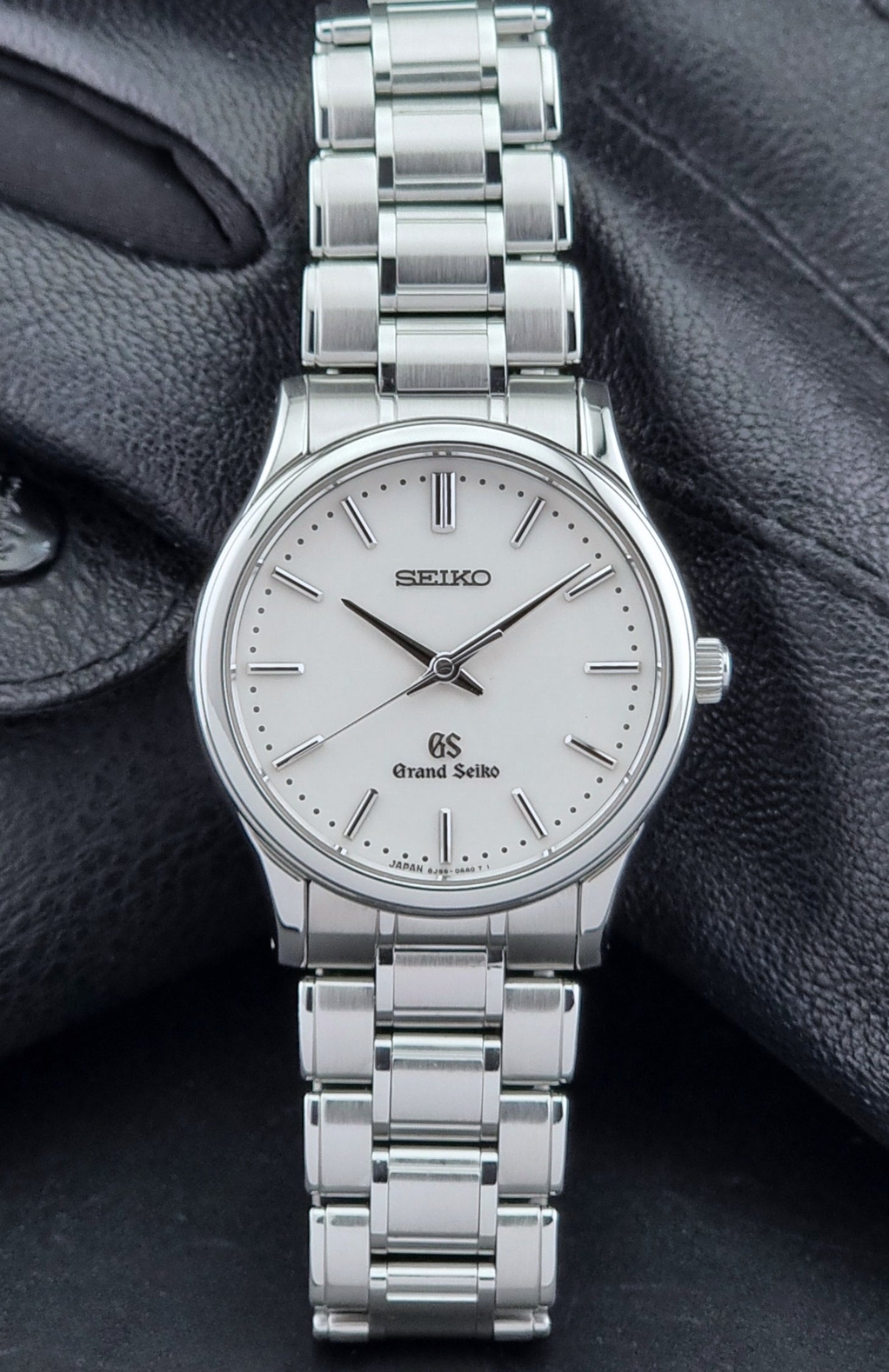 Grand Seiko SBGF027 quartz watch 8J55-0AA0 watch on a dark textured background close dial view