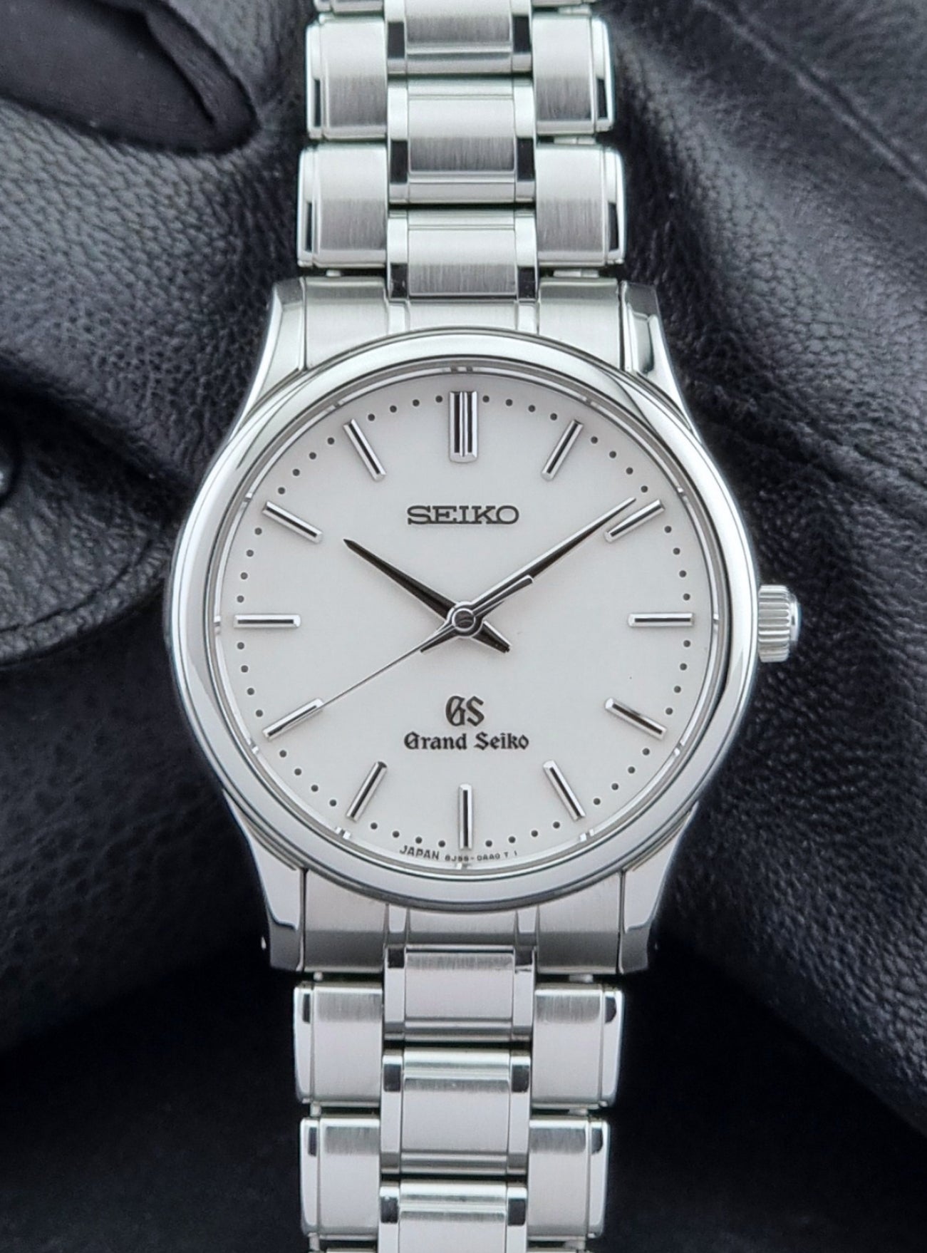 Grand Seiko SBGF027 quartz watch 8J55-0AA0 watch on a dark textured background close front view