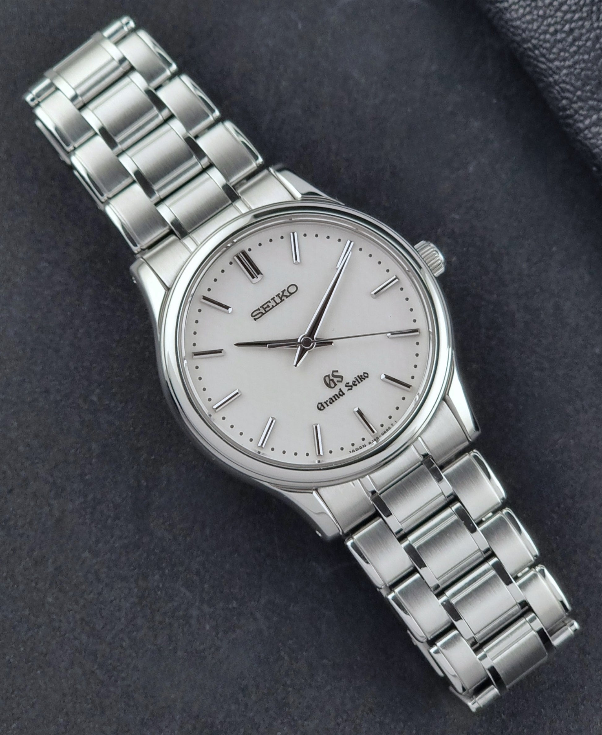 Grand Seiko SBGF027 quartz watch 8J55-0AA0 watch on a dark textured background front view