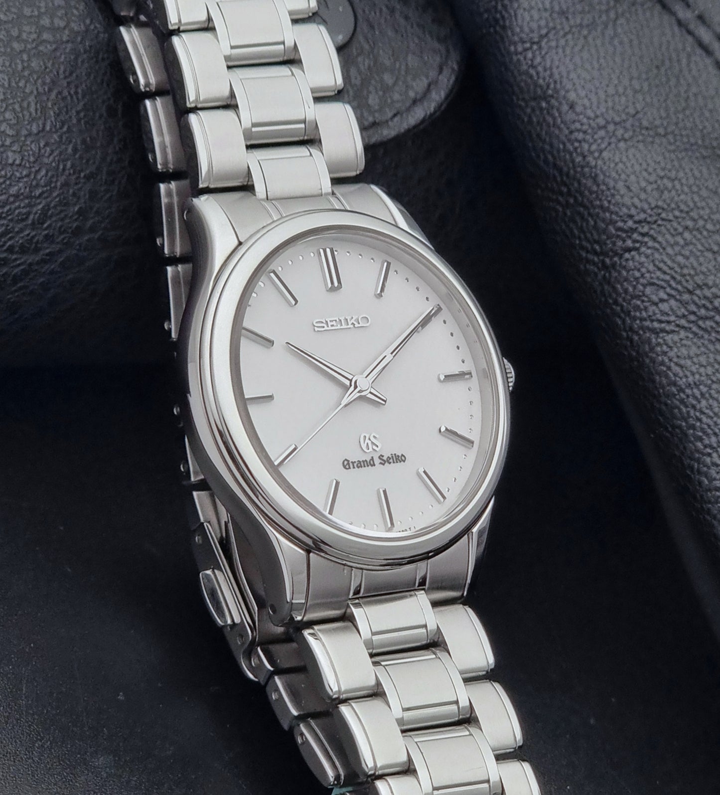 Grand Seiko SBGF027 quartz watch 8J55-0AA0 watch on a dark textured background side view