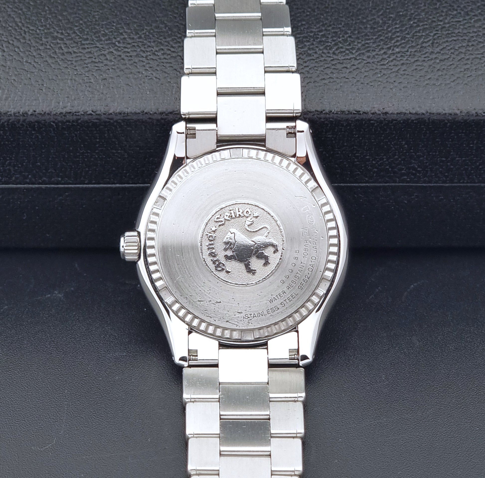Grand Seiko SBGX005 quartz watch 9F62-0A10 with a detailed face on a dark textured surface case back view