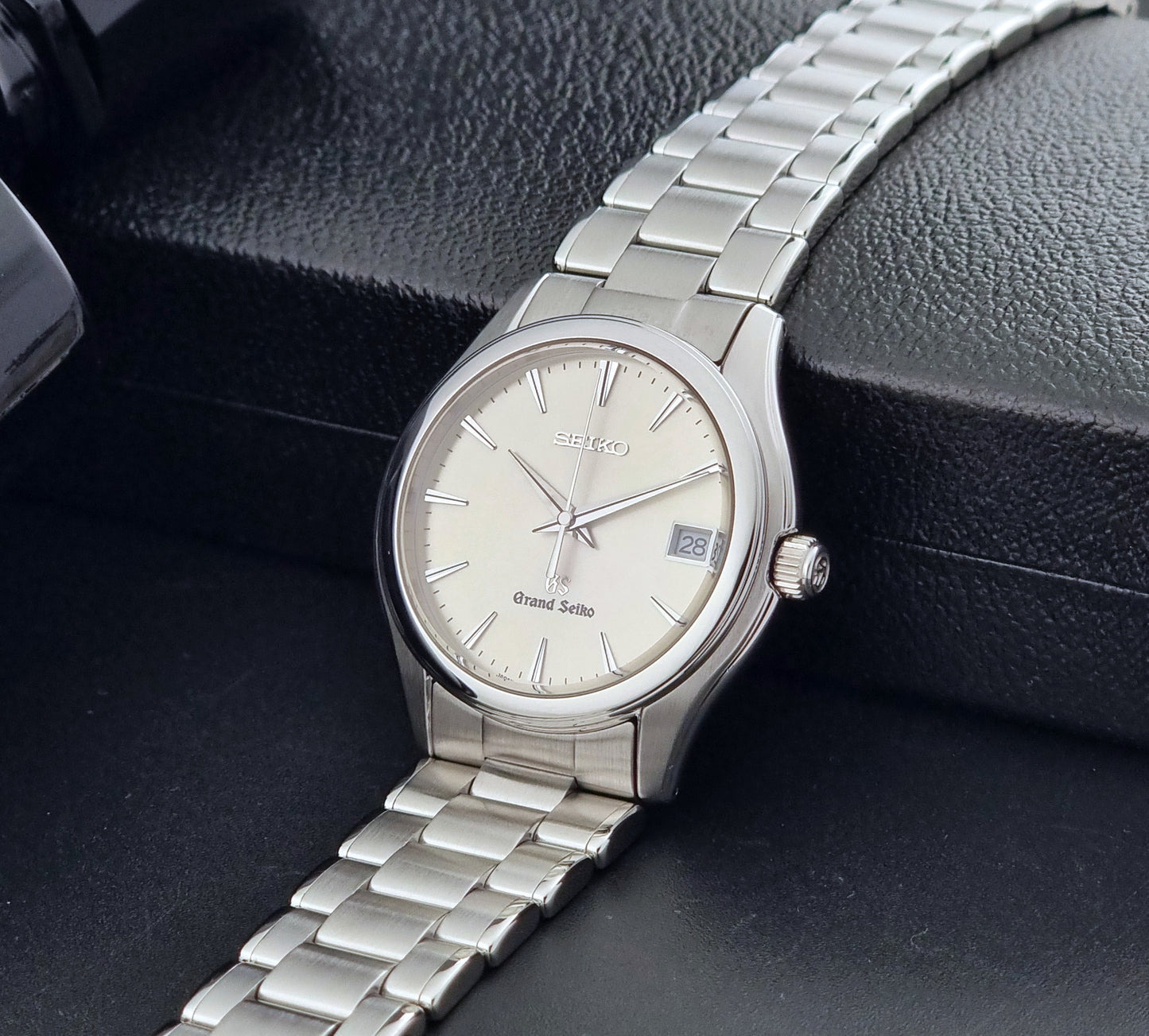 Grand Seiko SBGX005 quartz watch 9F62-0A10 with a detailed face on a dark textured surface crown view