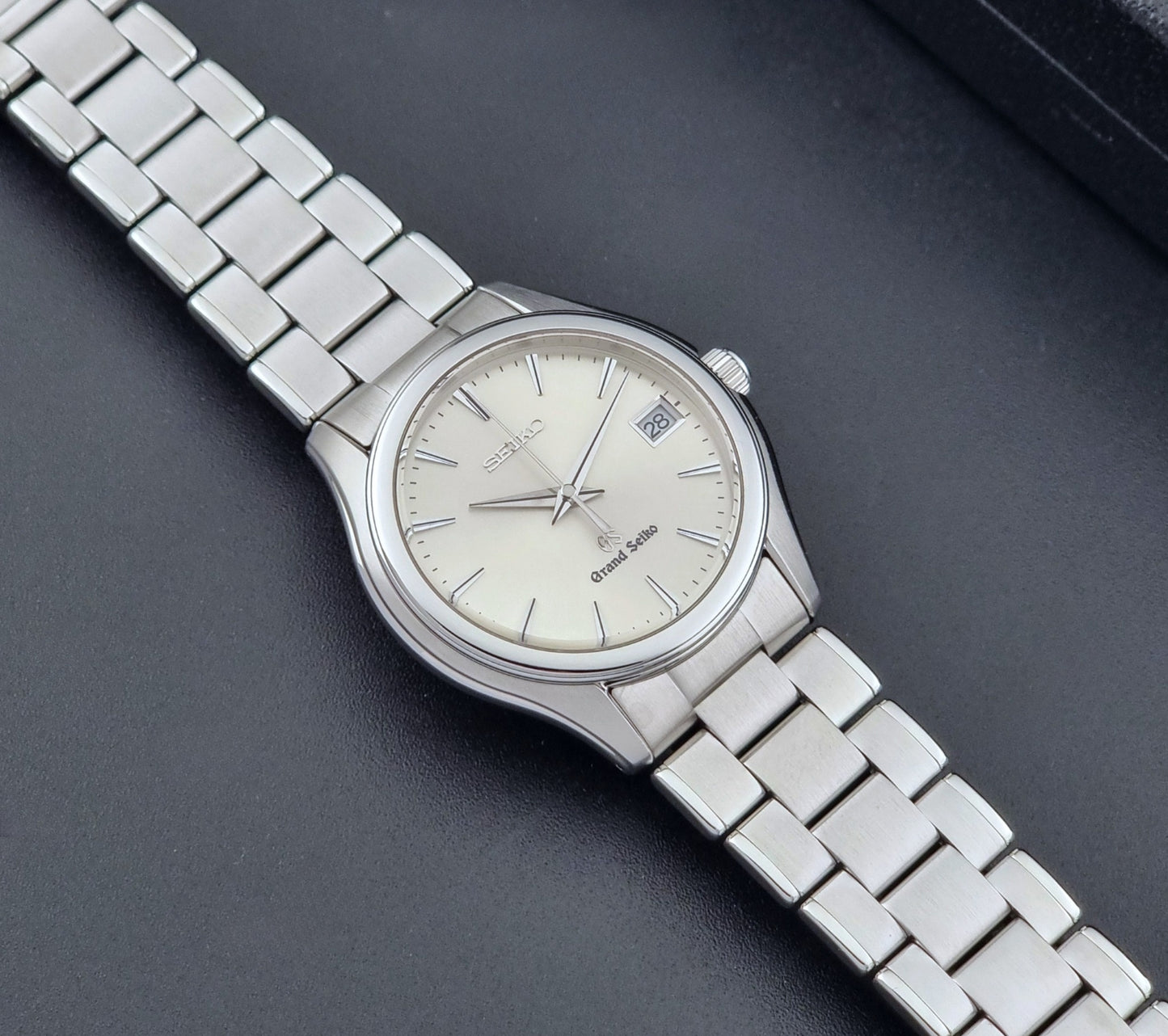 Grand Seiko SBGX005 quartz watch 9F62-0A10 with a detailed face on a dark textured surface closer up dial view