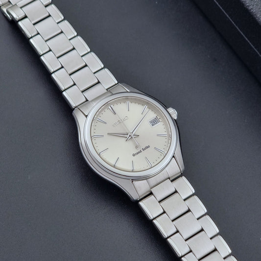 Grand Seiko SBGX005 quartz watch 9F62-0A10 with a detailed face on a dark textured surface dial