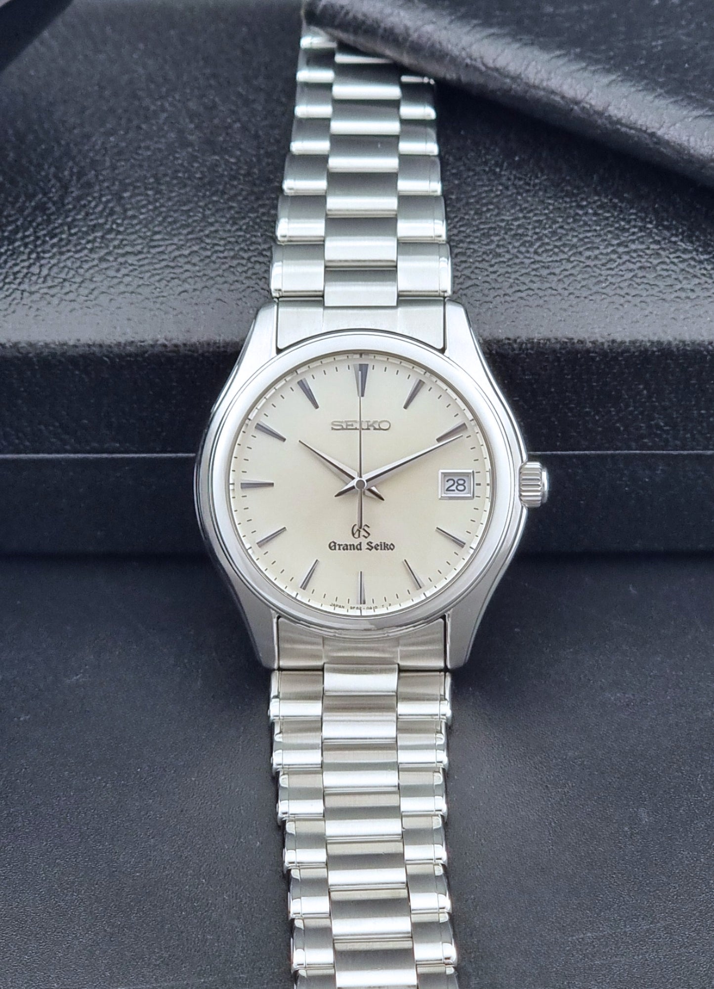 Grand Seiko SBGX005 quartz watch 9F62-0A10 with a detailed face on a dark textured surface dial view