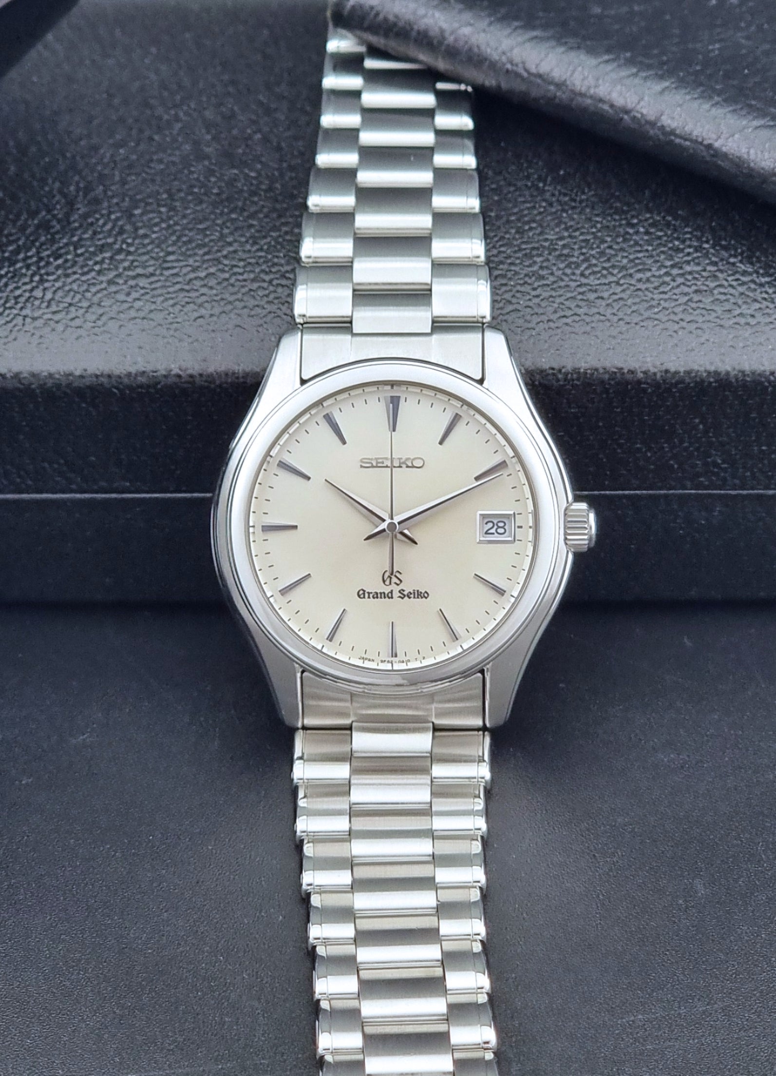 Grand Seiko SBGX005 quartz watch 9F62-0A10 with a detailed face on a dark textured surface dial view