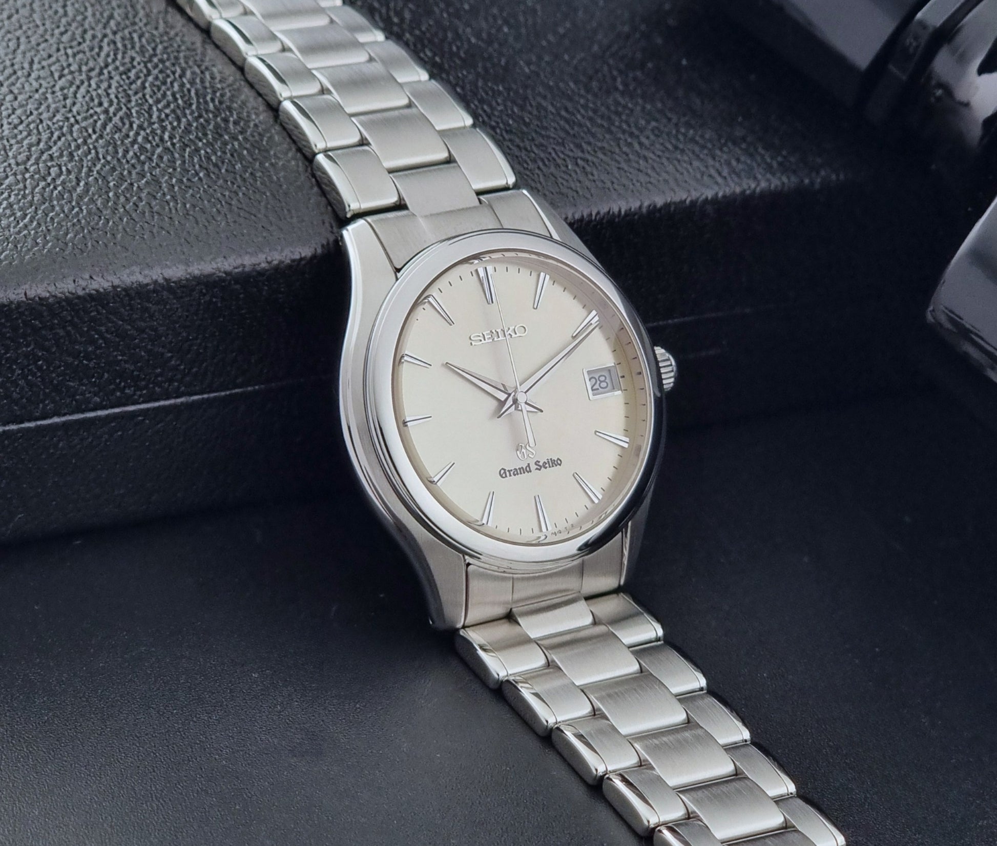 Grand Seiko SBGX005 quartz watch 9F62-0A10 with a detailed face on a dark textured surface side view