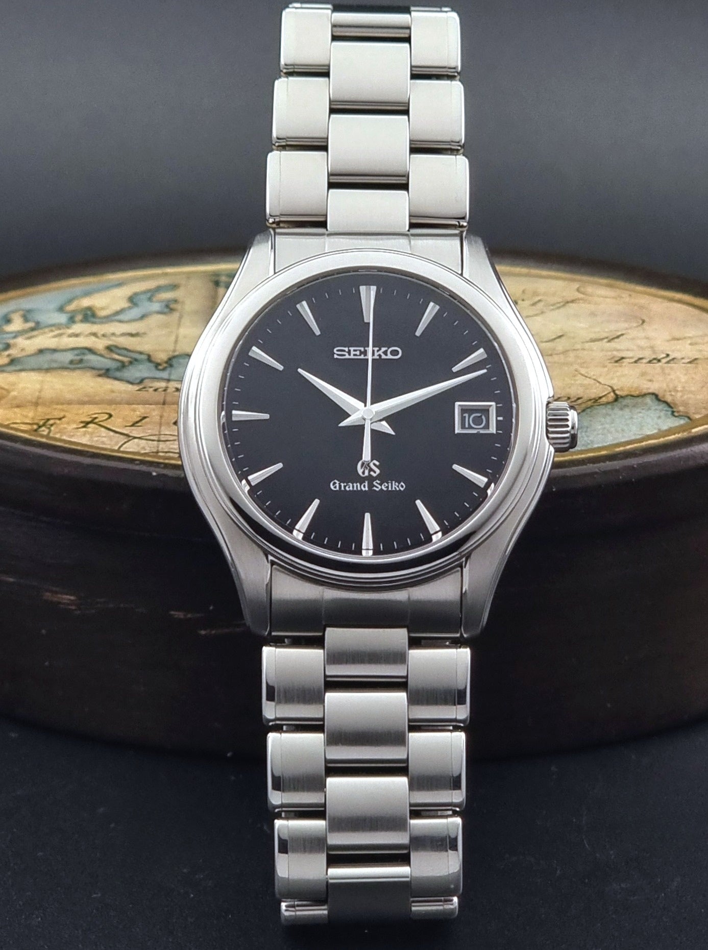Grand Seiko quartz SBGX041 watch with black dial on a dark background