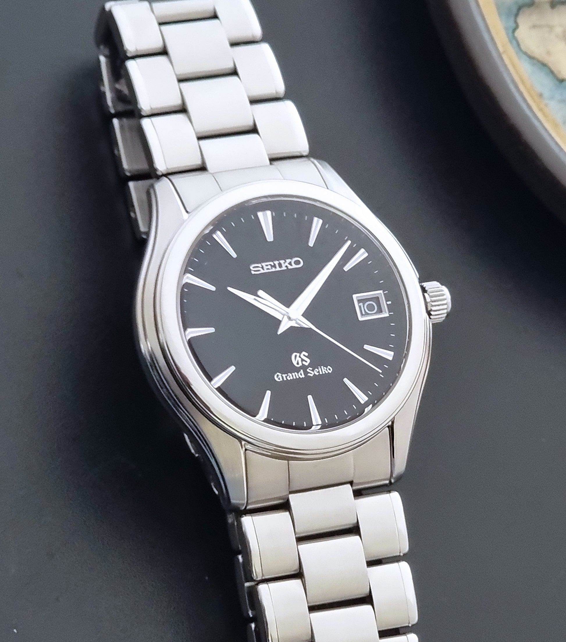 Grand Seiko quartz SBGX041 watch with black dial on a dark background close up of the matt dial