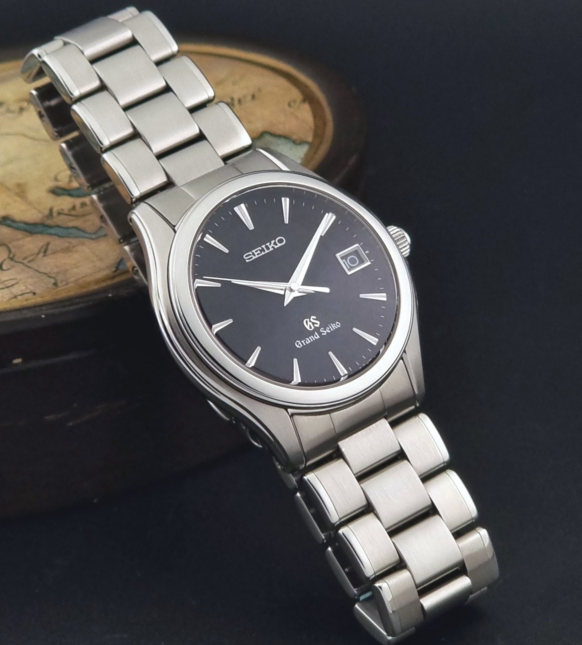 Grand Seiko quartz SBGX041 watch with black dial on a dark background