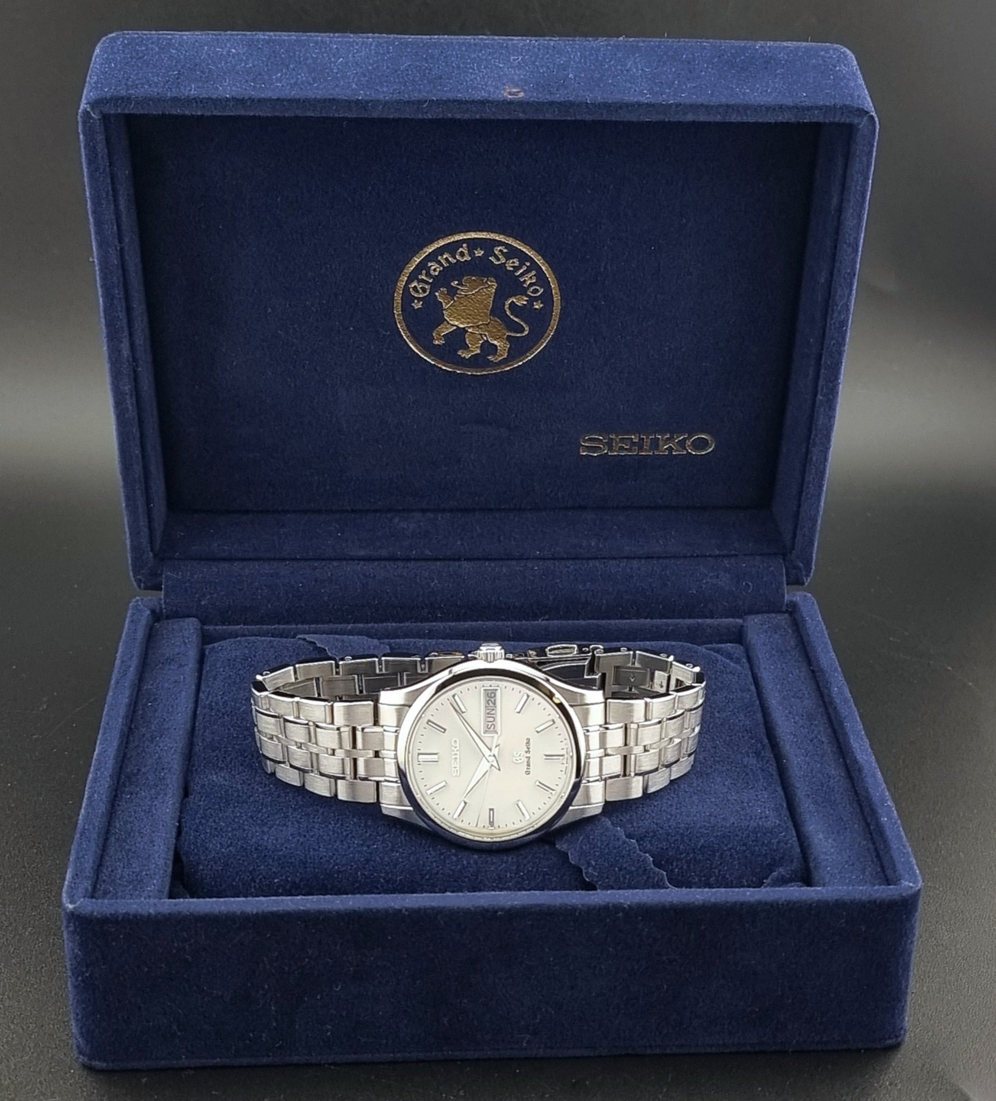 Vintage Grand Seiko SBGT005 quartz watch 9F83-9A30 with bracelet on a dark background box view
