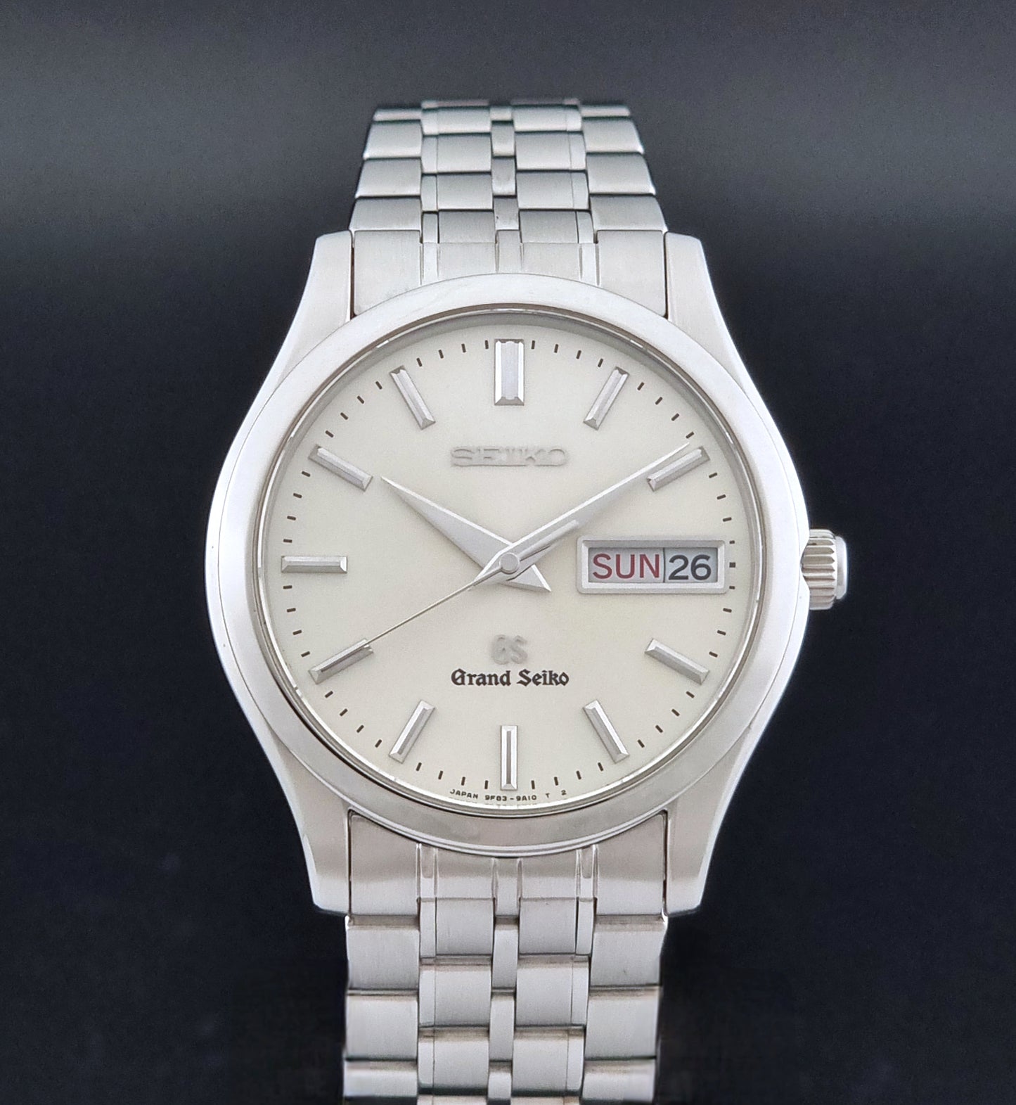 Vintage Grand Seiko SBGT005 quartz watch 9F83-9A30 with bracelet on a dark background close dial view