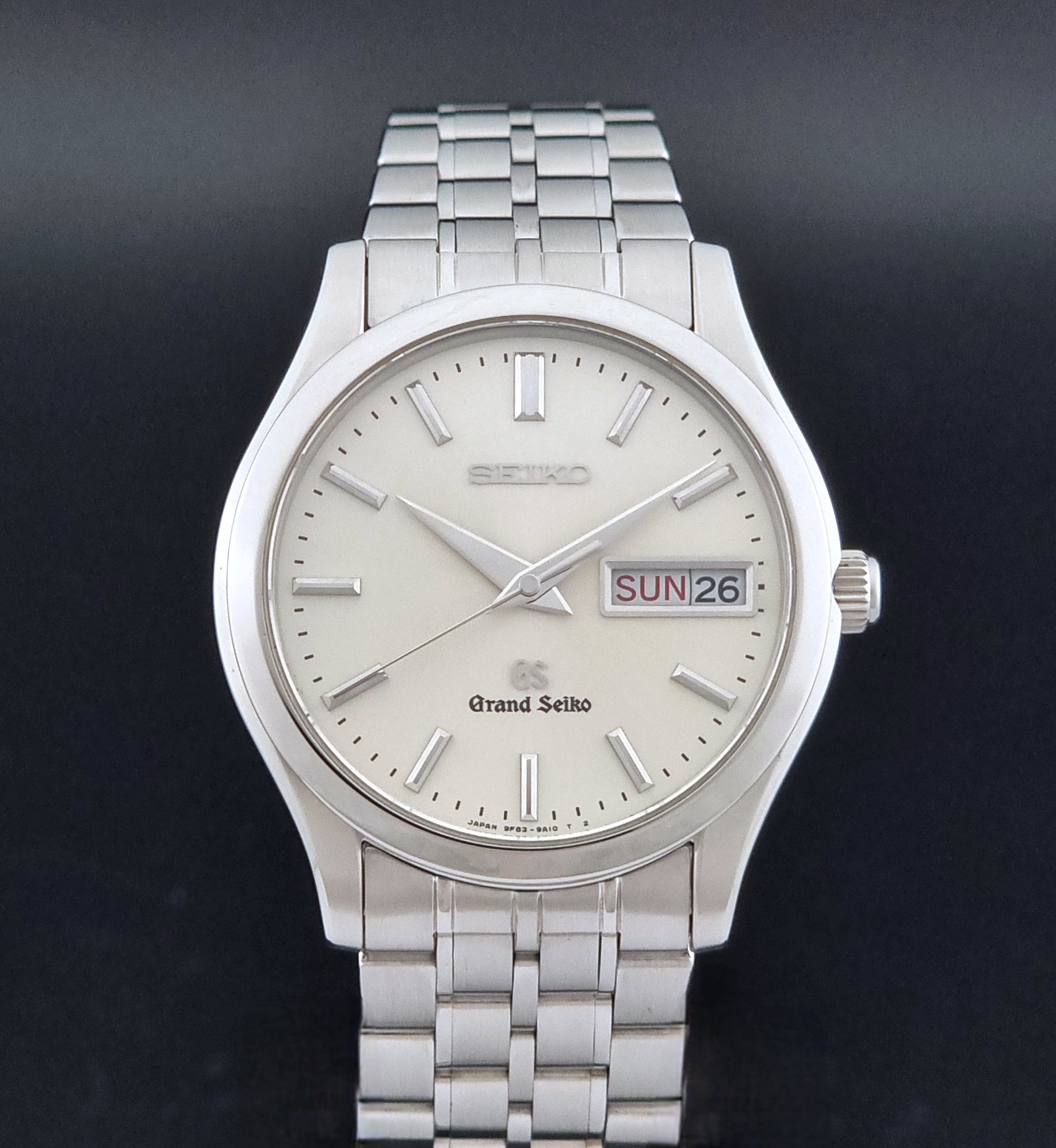 Vintage Grand Seiko SBGT005 quartz watch 9F83-9A30 with bracelet on a dark background close dial view