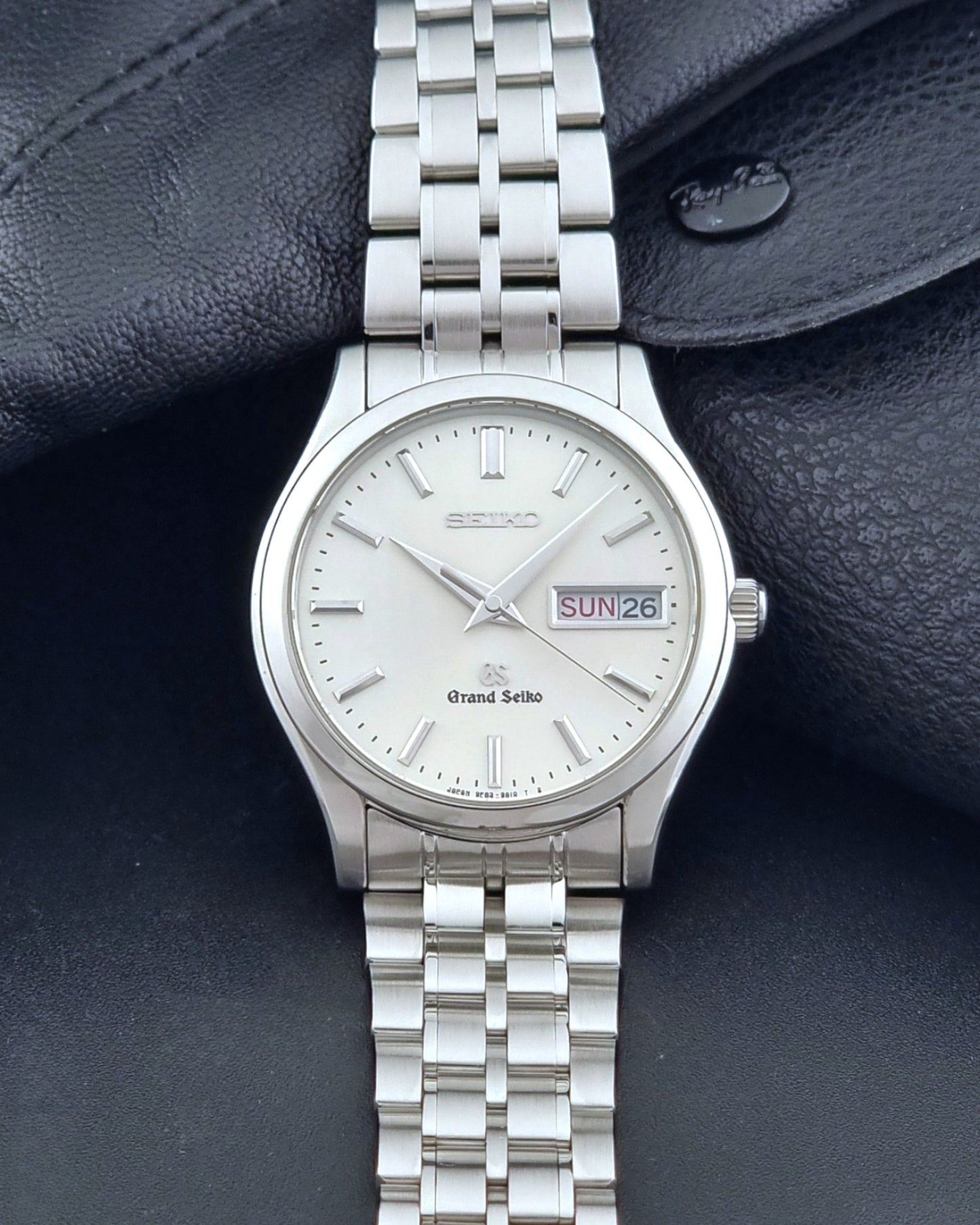 Vintage Grand Seiko SBGT005 quartz watch 9F83-9A30 with bracelet on a dark background dial view