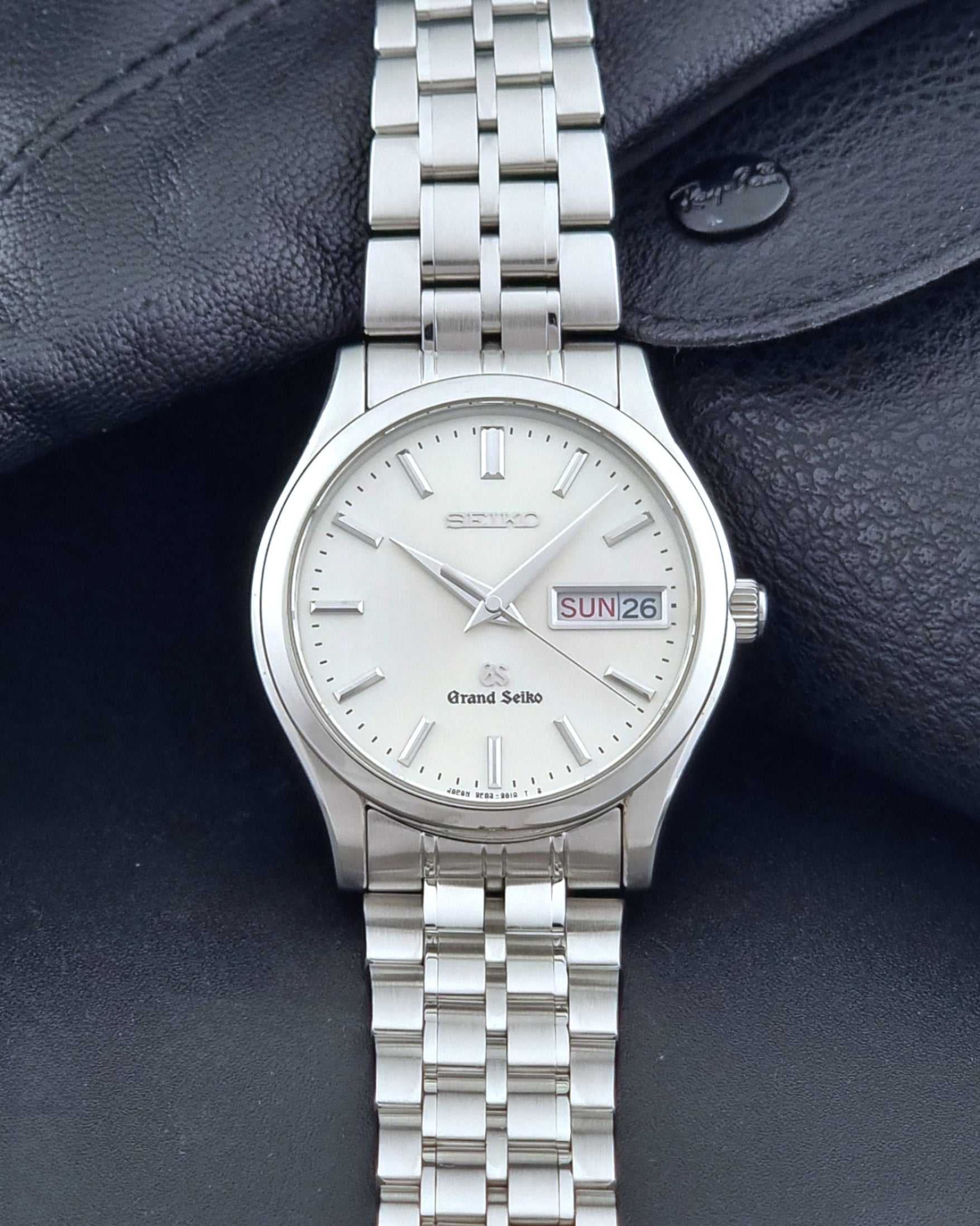 Vintage Grand Seiko SBGT005 quartz watch 9F83-9A30 with bracelet on a dark background dial view