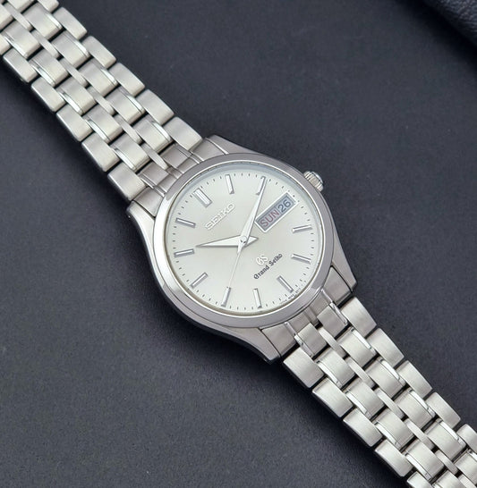 Vintage Grand Seiko SBGT005 quartz watch 9F83-9A30 with bracelet on a dark background dial