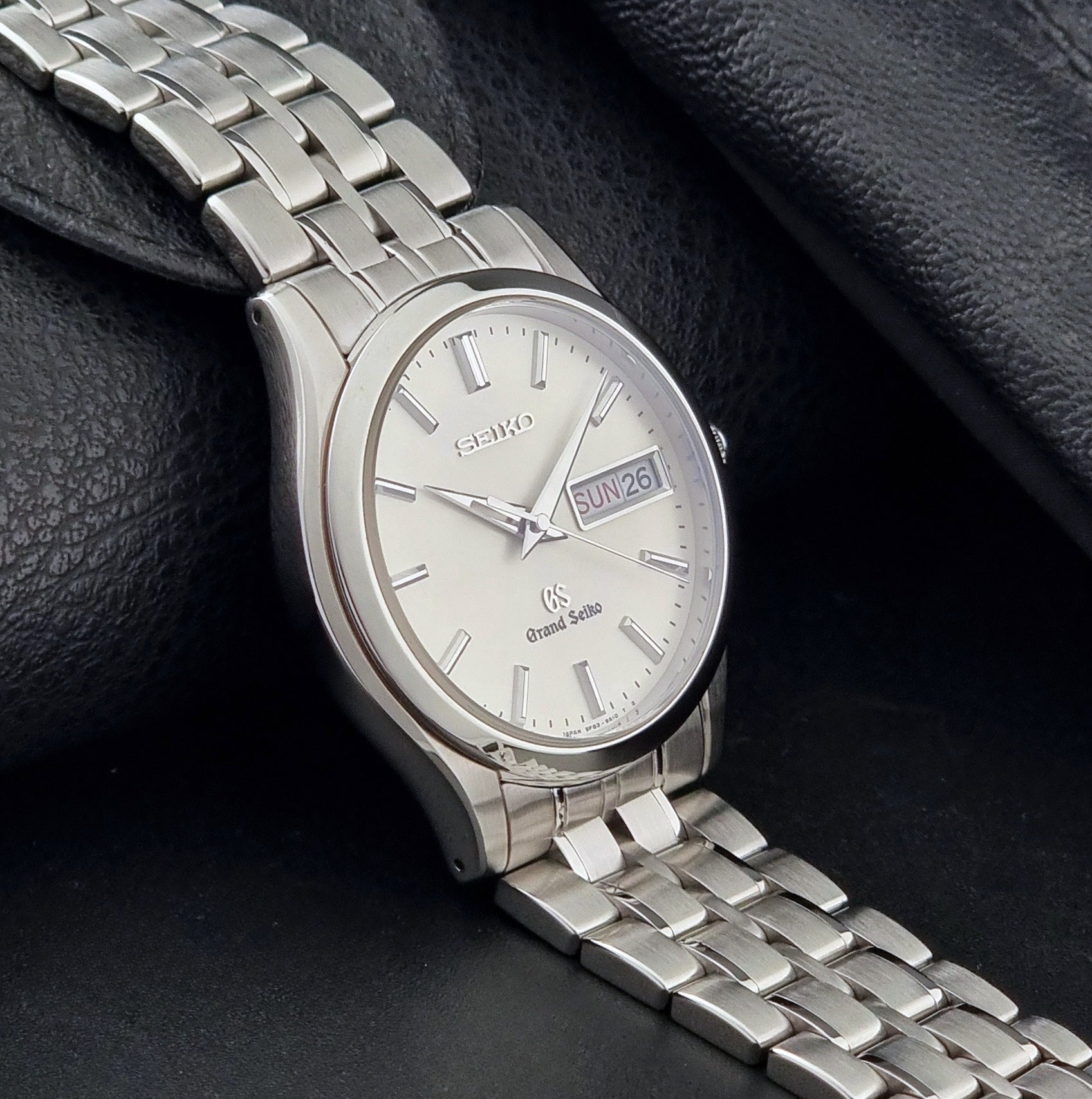 Vintage Grand Seiko SBGT005 quartz watch 9F83-9A30 with bracelet on a dark background side view