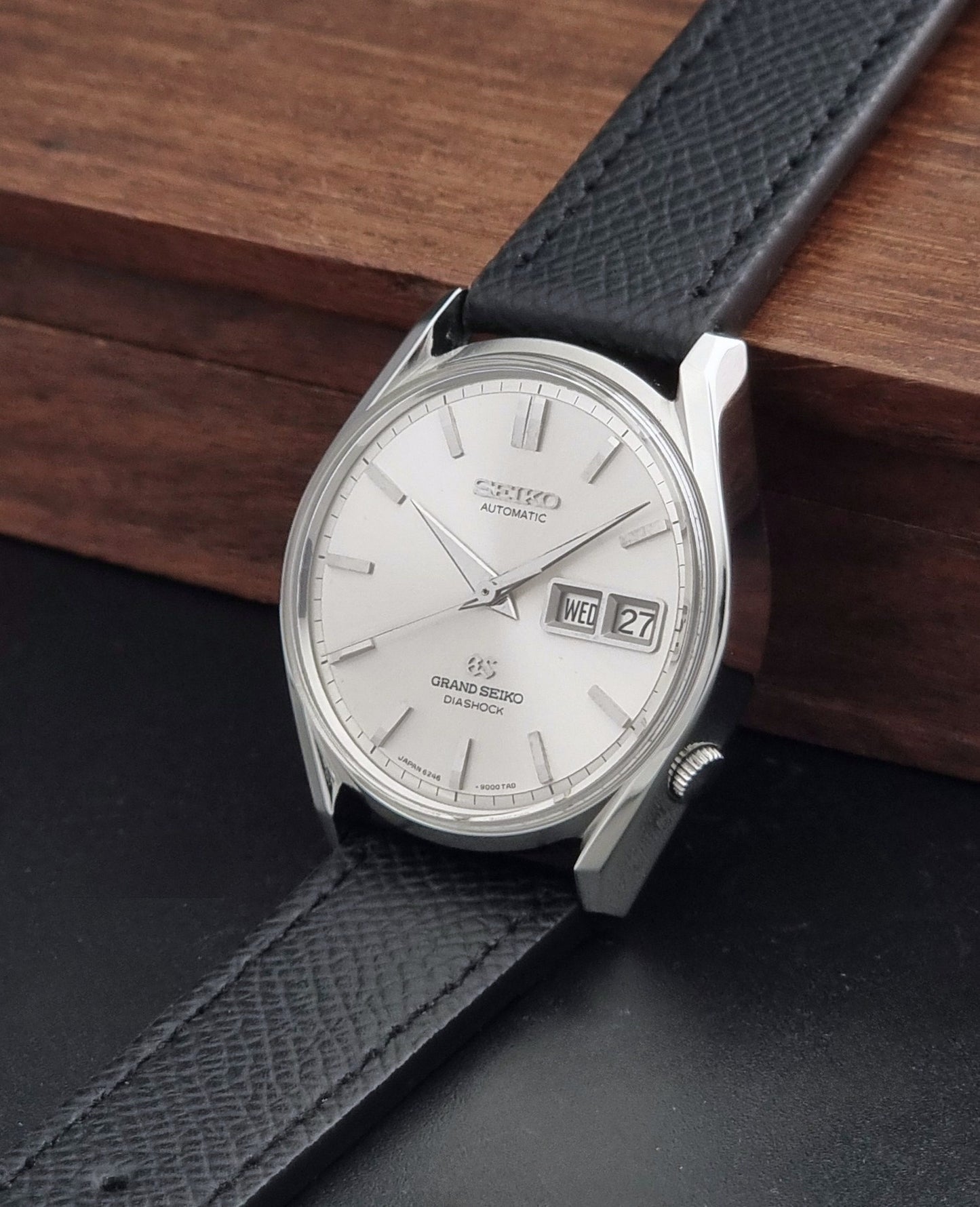 Vintage Grand Seiko 6246-9001 Wristwatch on a dark background crown view