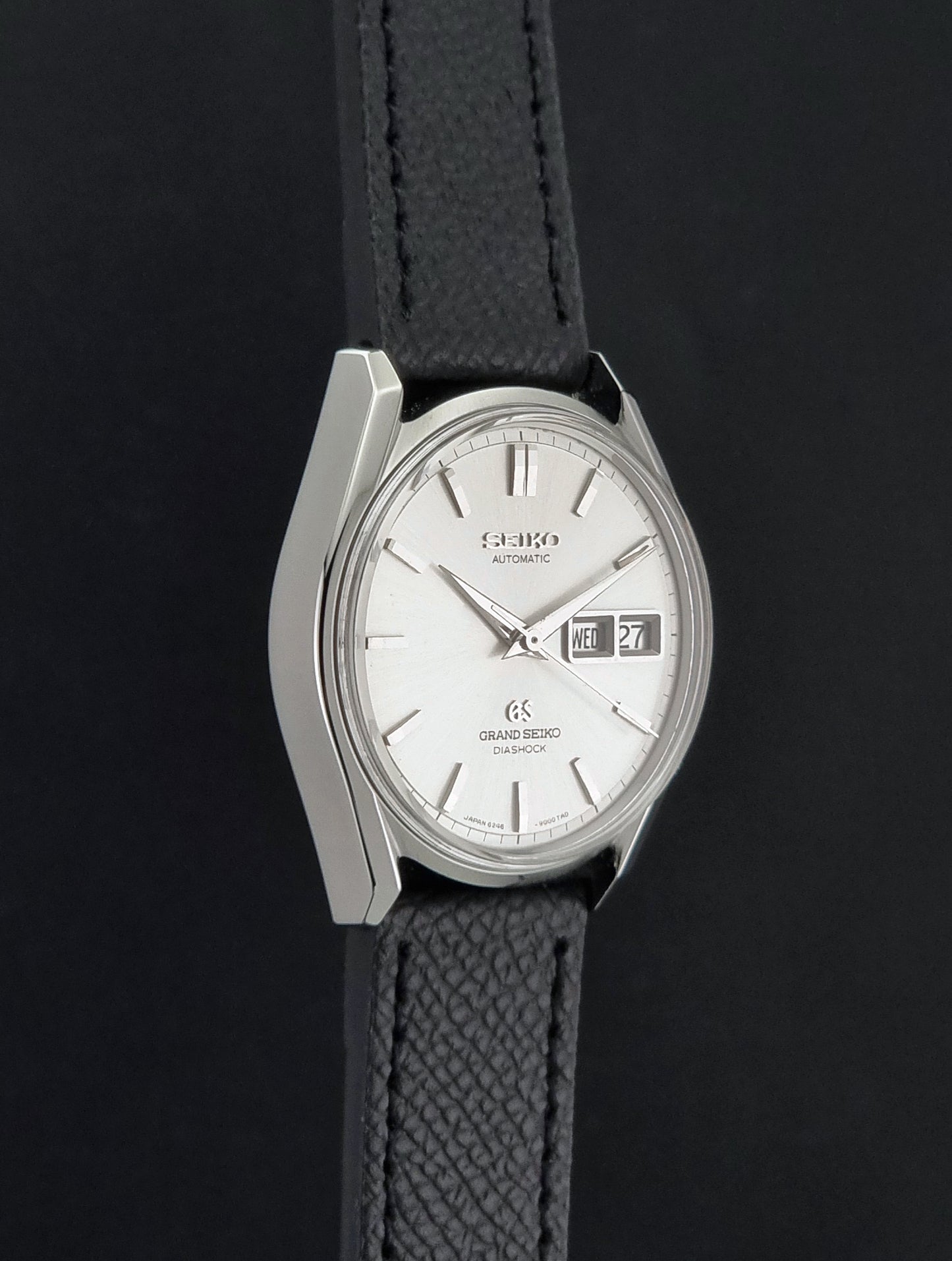 Vintage Grand Seiko 6246-9001 Wristwatch on a dark background side profile view