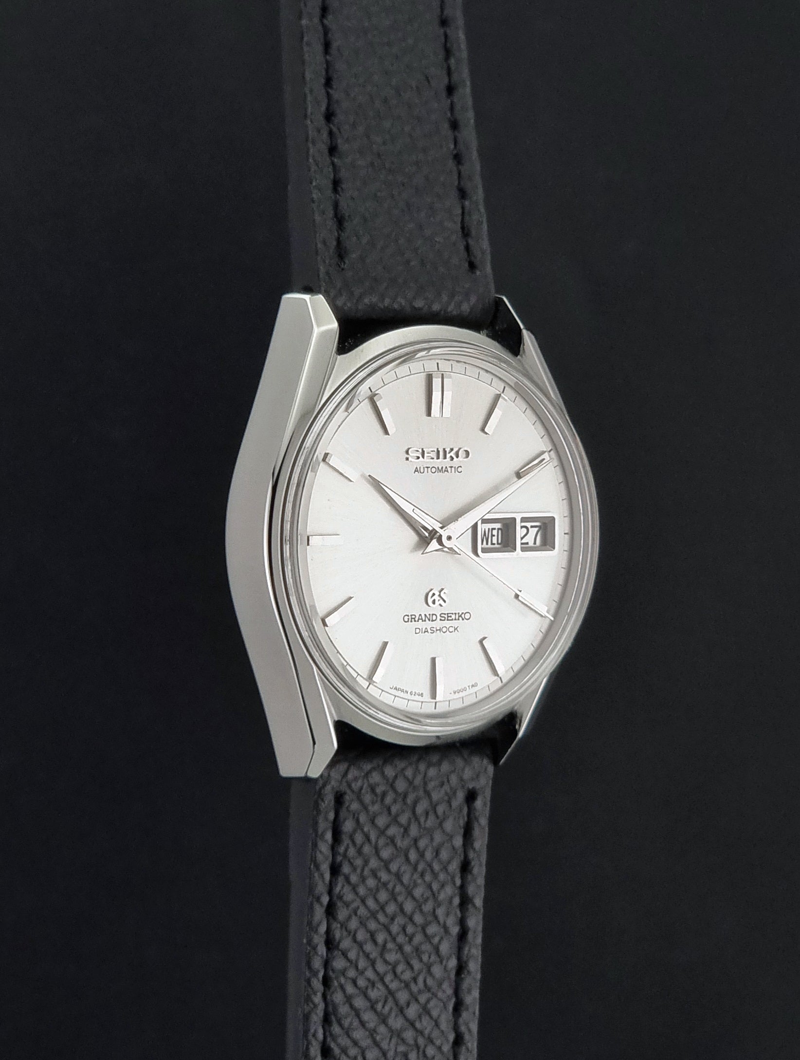 Vintage Grand Seiko 6246-9001 Wristwatch on a dark background side profile view
