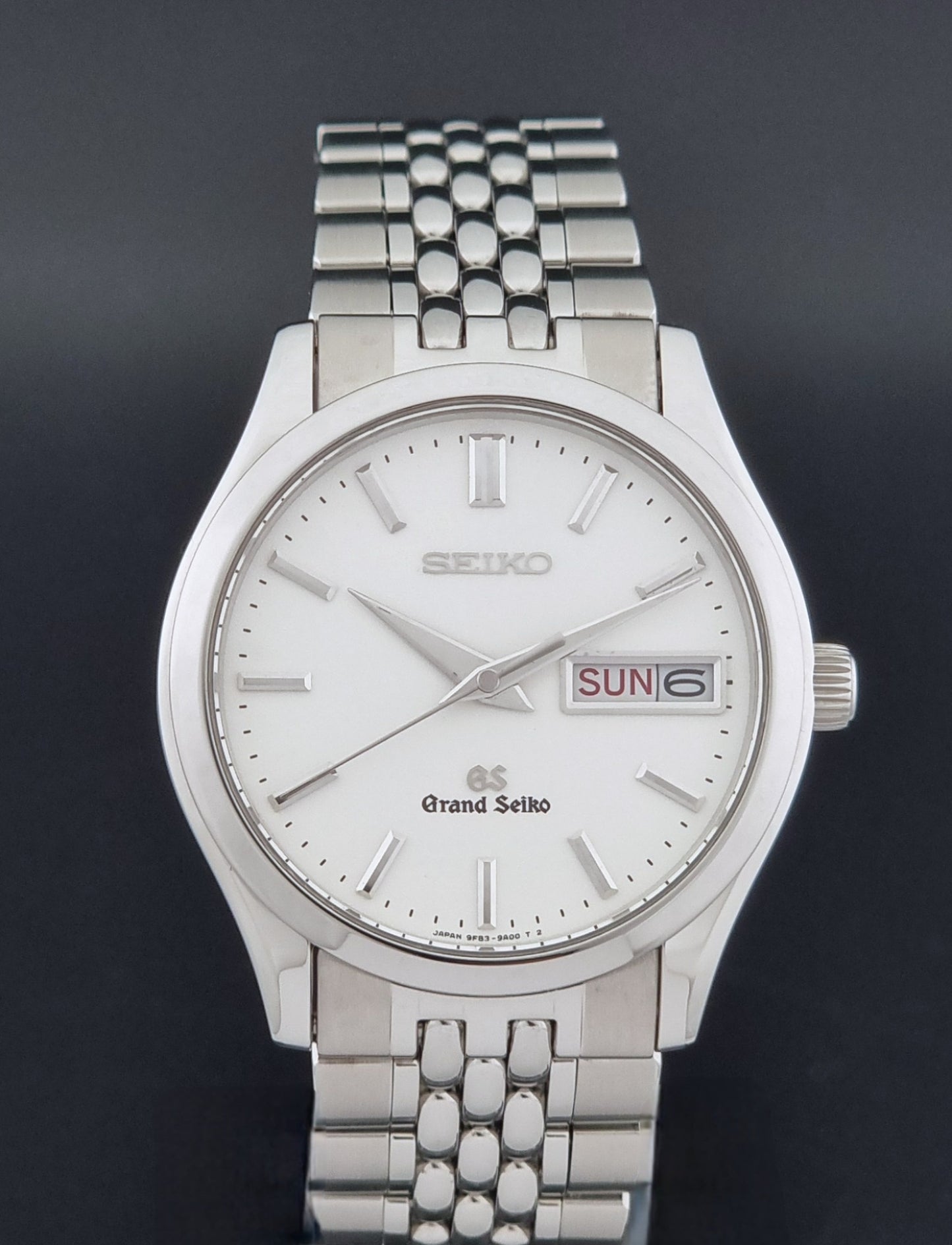 Vintage Grand Seiko watch SBGT001 9F83-9A00 with a white dial on a dark background close dial view