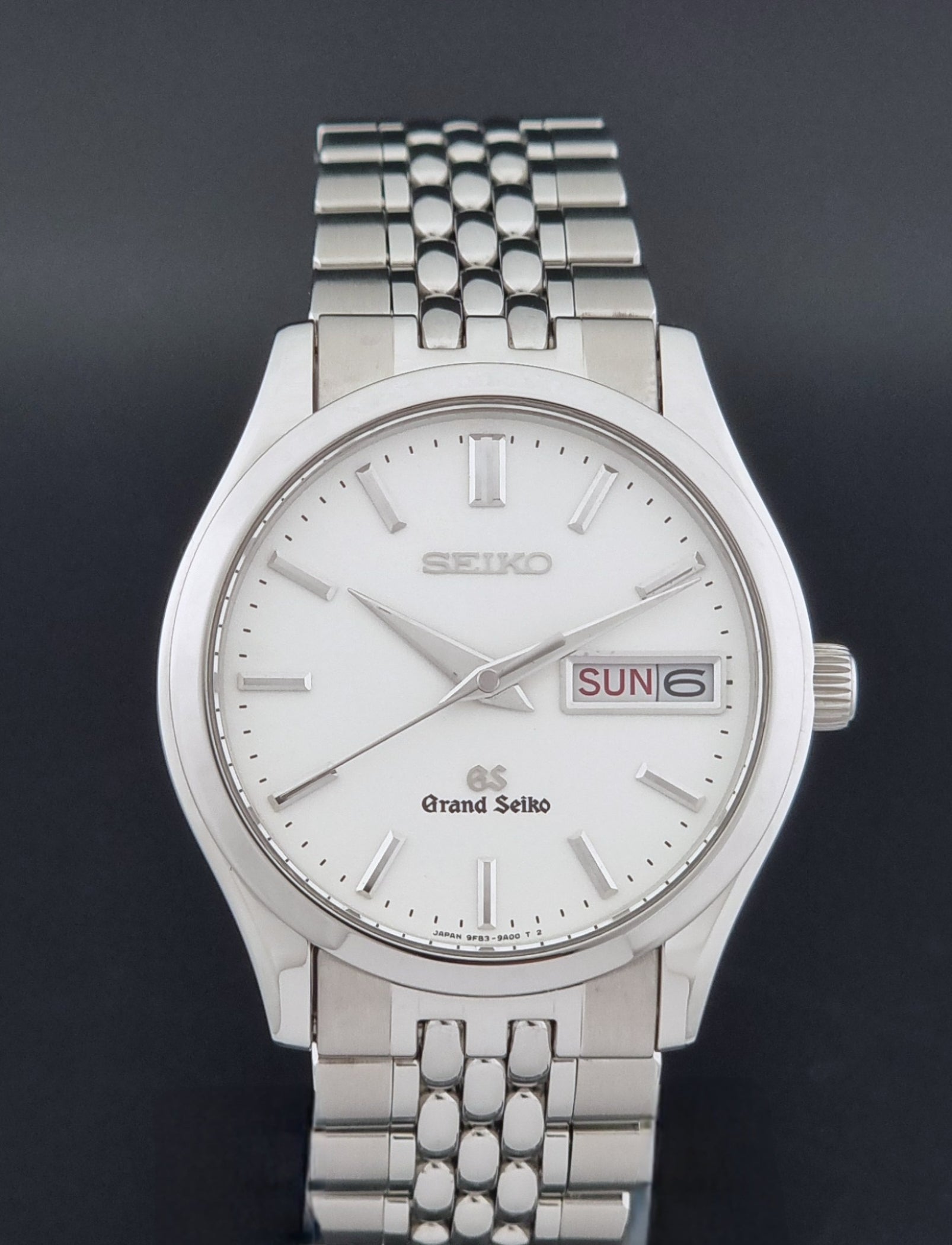 Vintage Grand Seiko watch SBGT001 9F83-9A00 with a white dial on a dark background close dial view