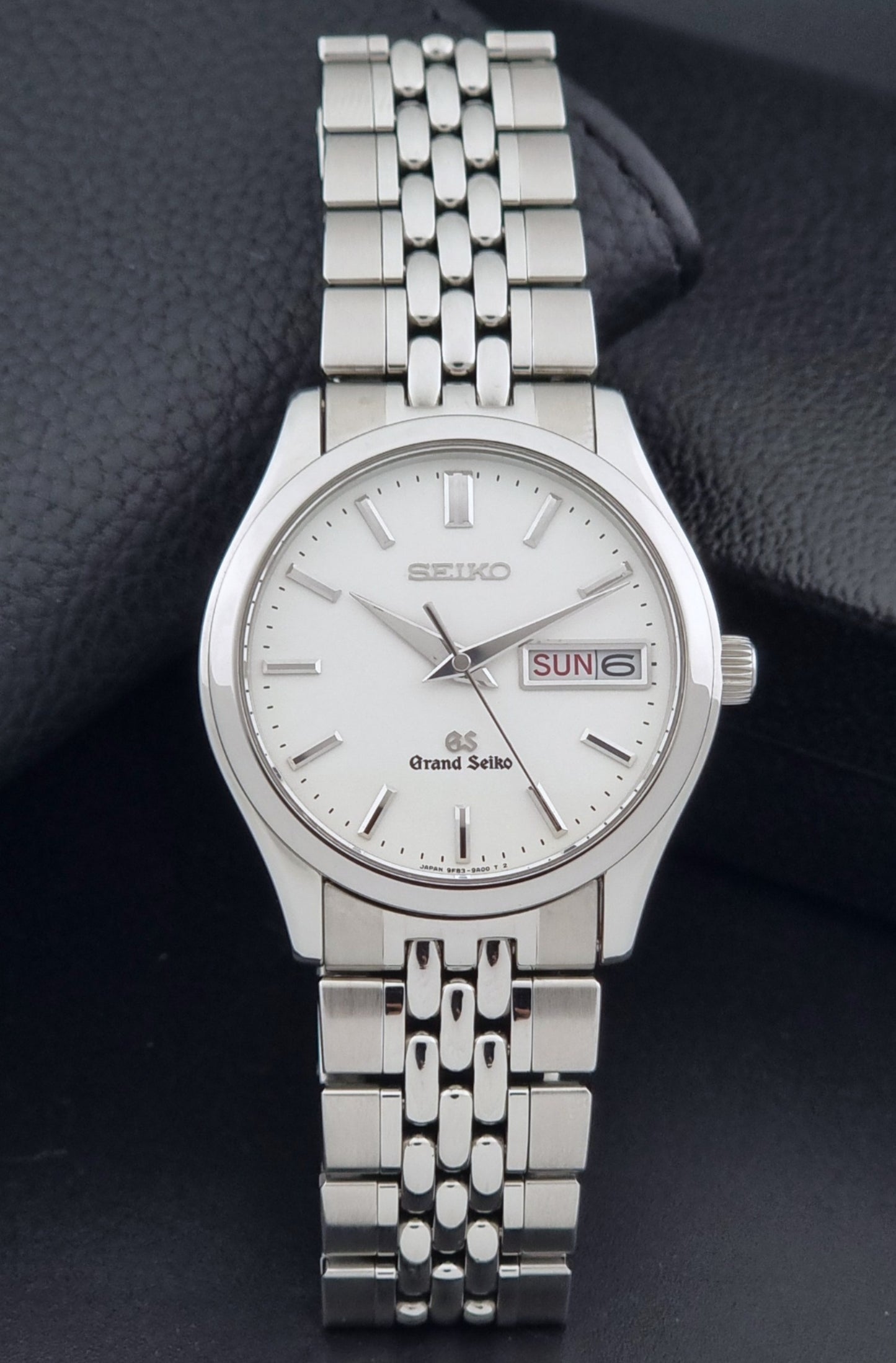 Vintage Grand Seiko watch SBGT001 9F83-9A00 with a white dial on a dark background dial view