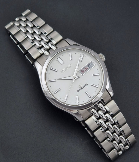 Vintage Grand Seiko watch SBGT001 9F83-9A00 with a white dial on a dark background dial