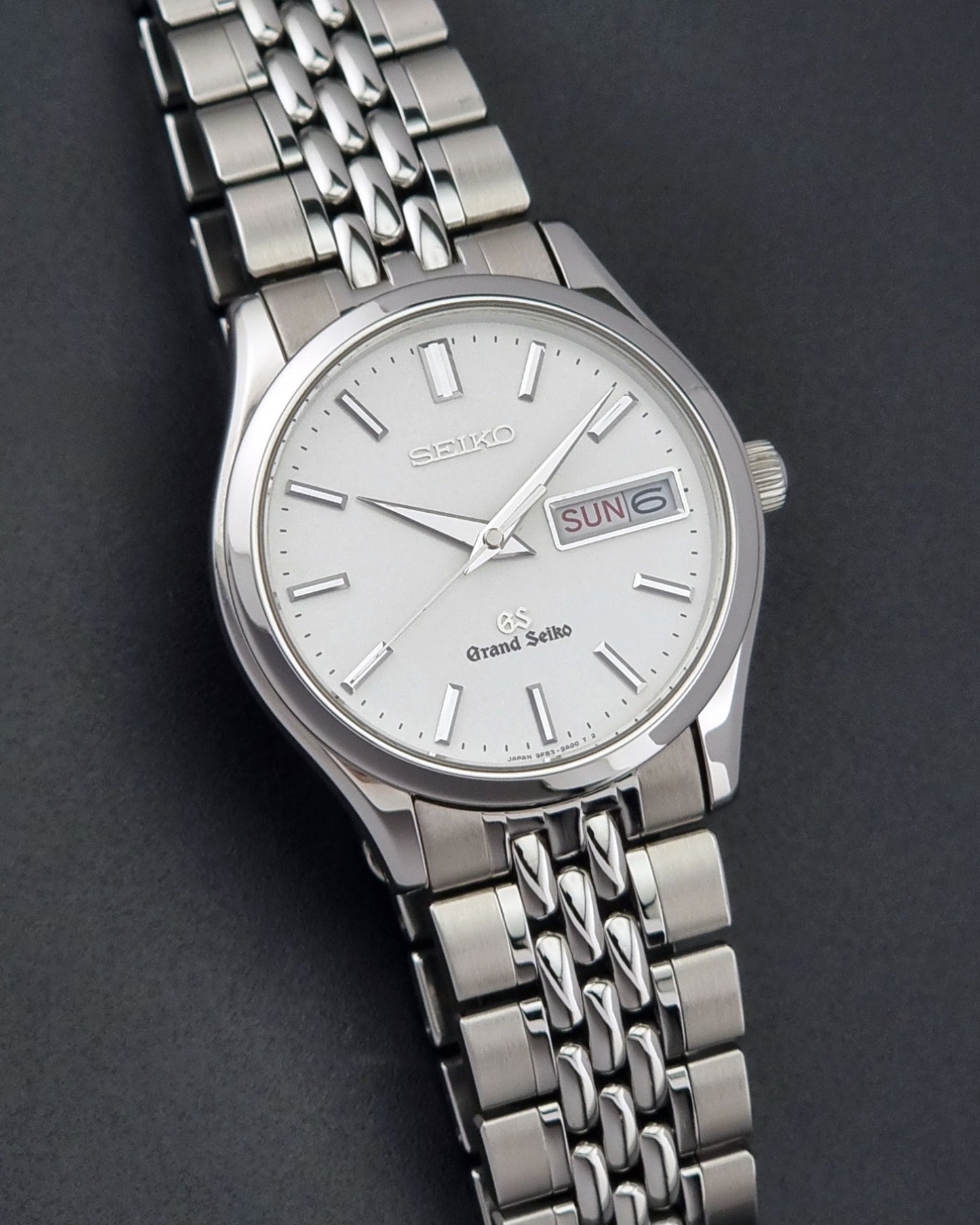 Vintage Grand Seiko watch SBGT001 9F83-9A00 with a white dial on a dark background front view
