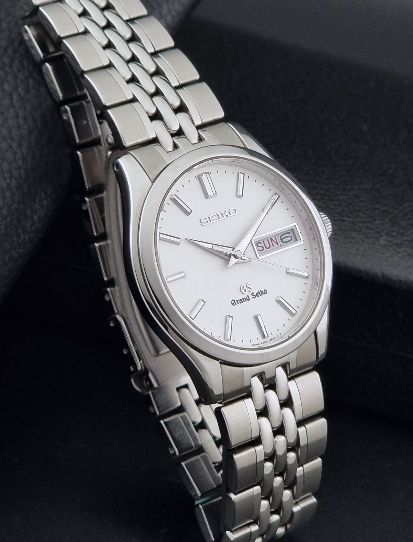 Vintage Grand Seiko watch SBGT001 9F83-9A00 with a white dial on a dark background side view