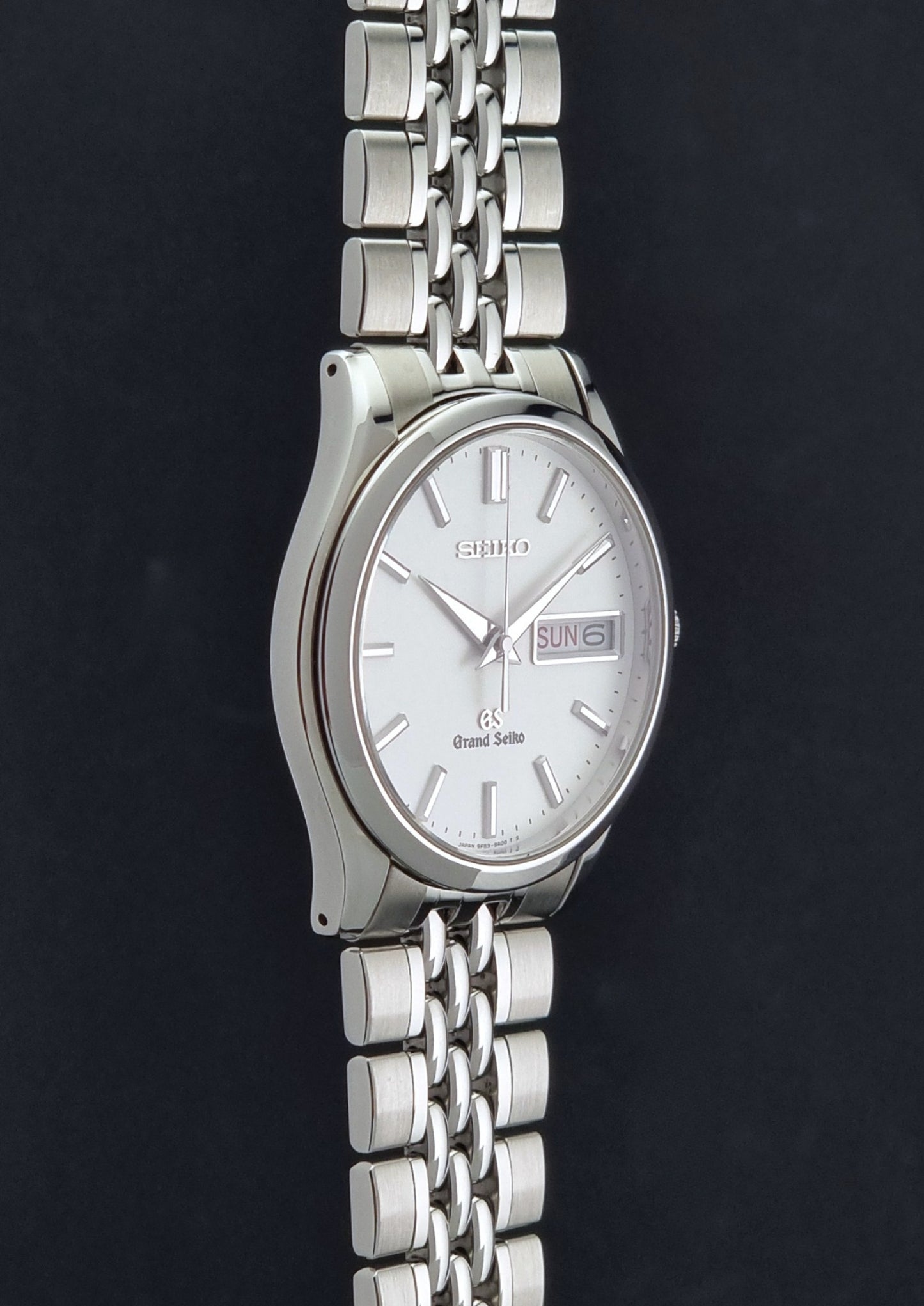 Vintage Grand Seiko watch SBGT001 9F83-9A00 with a white dial on a dark background side profile view
