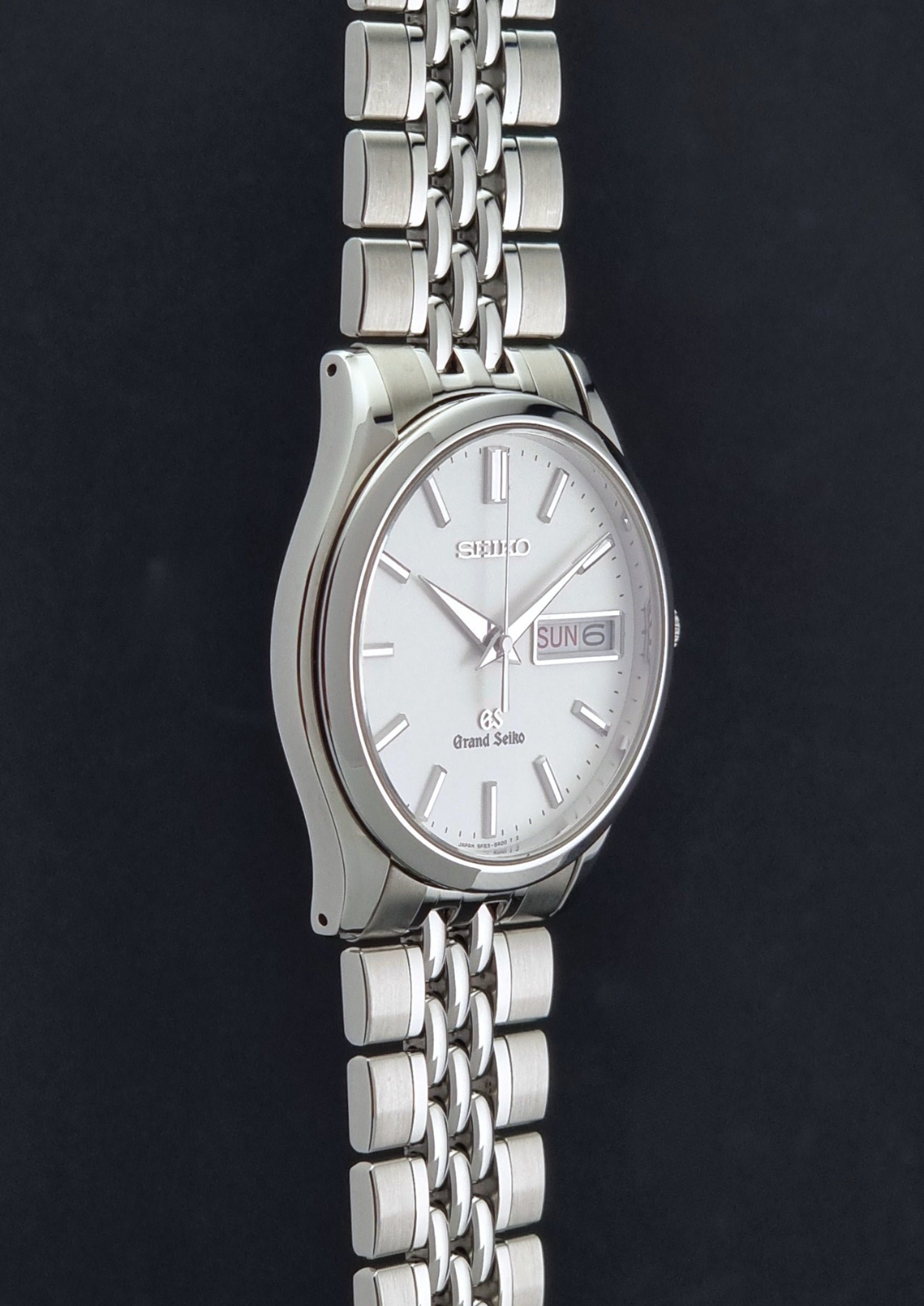 Vintage Grand Seiko watch SBGT001 9F83-9A00 with a white dial on a dark background side profile view