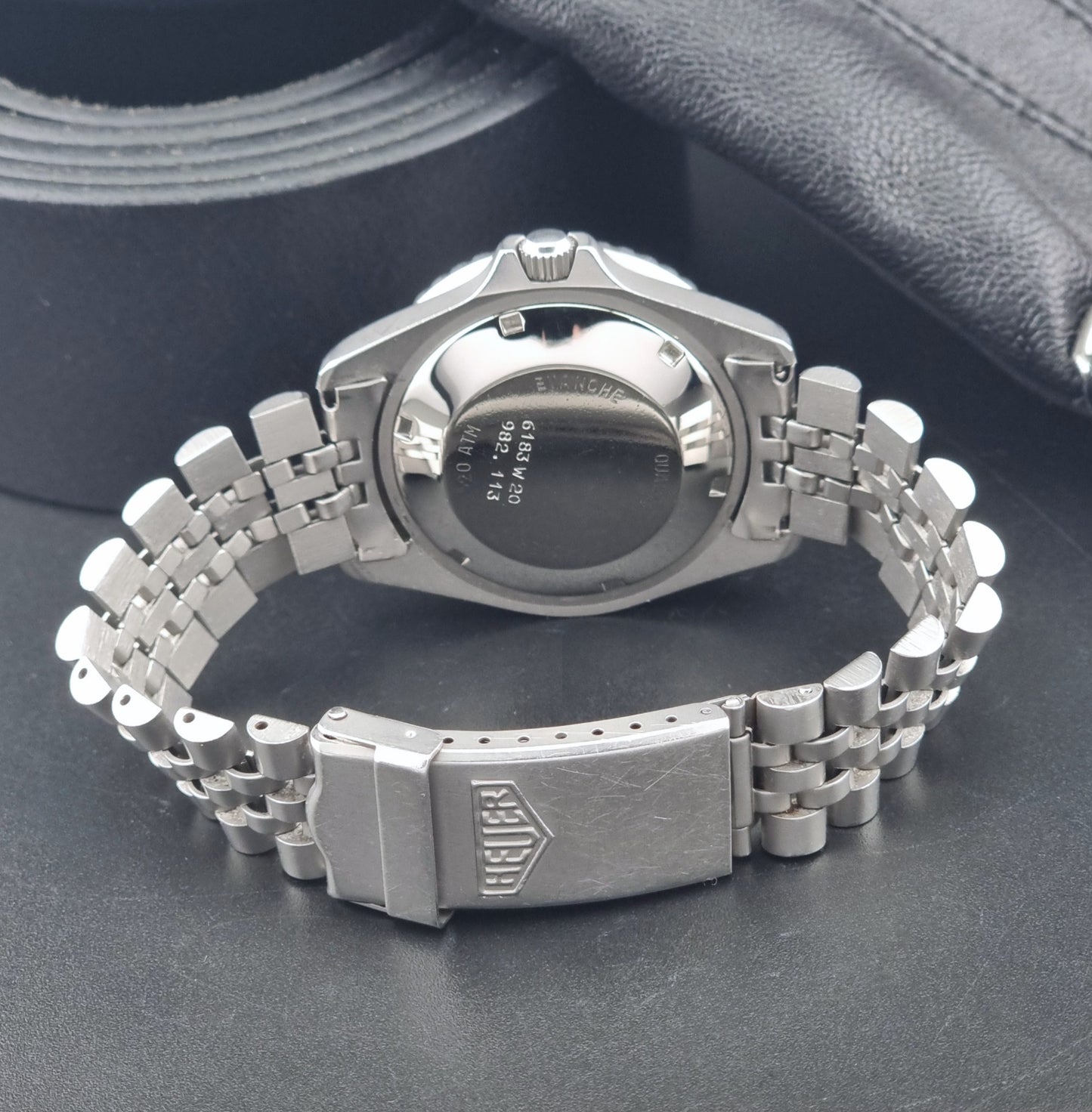 Vintage Heuer Wristwatch Professional Quartz Night Diver 982.113 with a pewter colours pvd coated case on a dark background clasp view