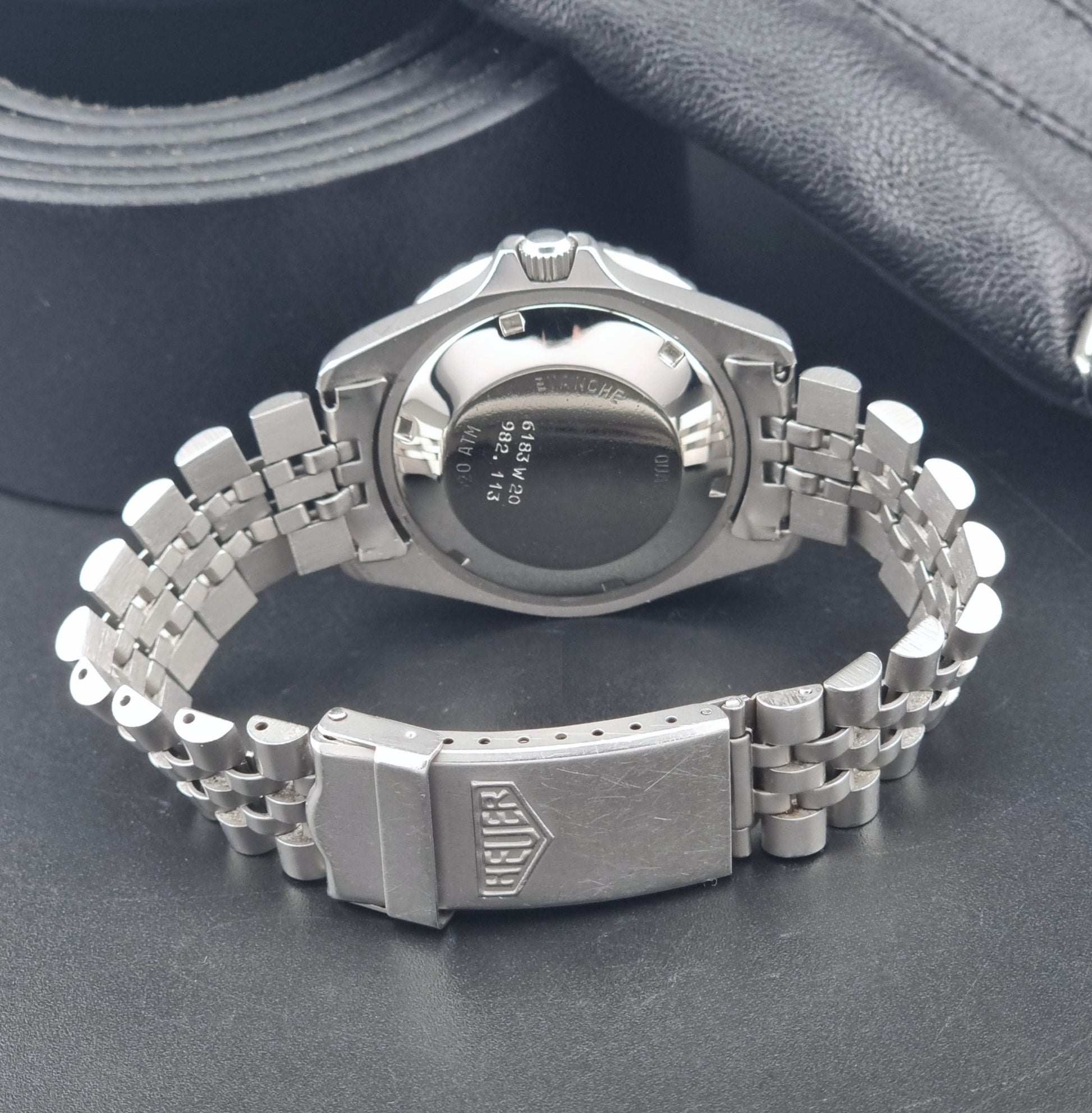 Vintage Heuer Wristwatch Professional Quartz Night Diver 982.113 with a pewter colours pvd coated case on a dark background clasp view