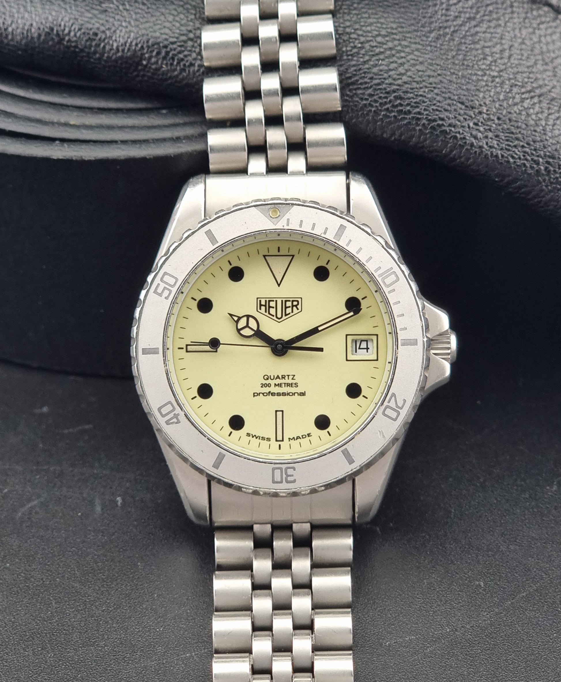 Vintage Heuer Wristwatch Professional Quartz Night Diver 982.113 with a pewter colours pvd coated case on a dark background dial view