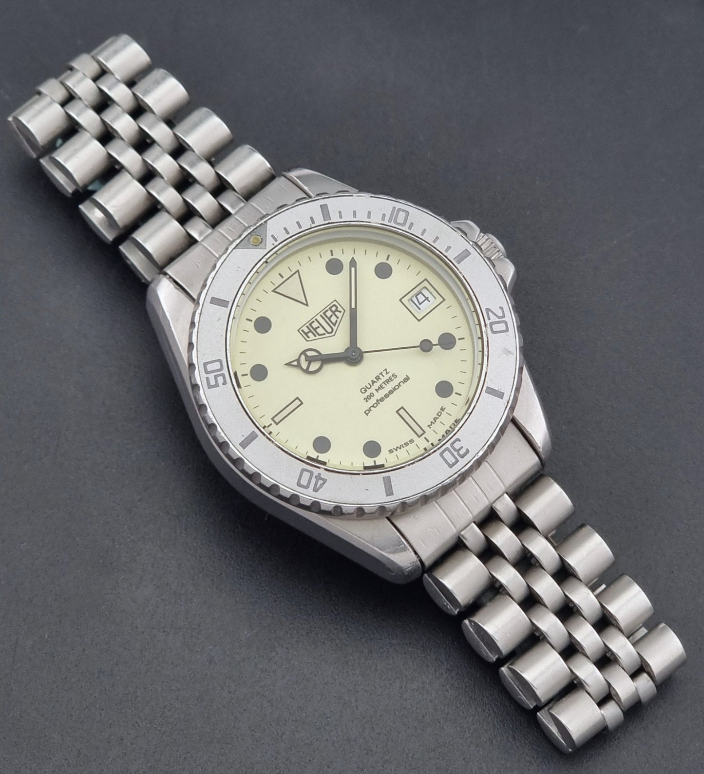 Vintage Heuer Wristwatch Professional Quartz Night Diver 982.113 with a pewter colours pvd coated case on a dark background dial