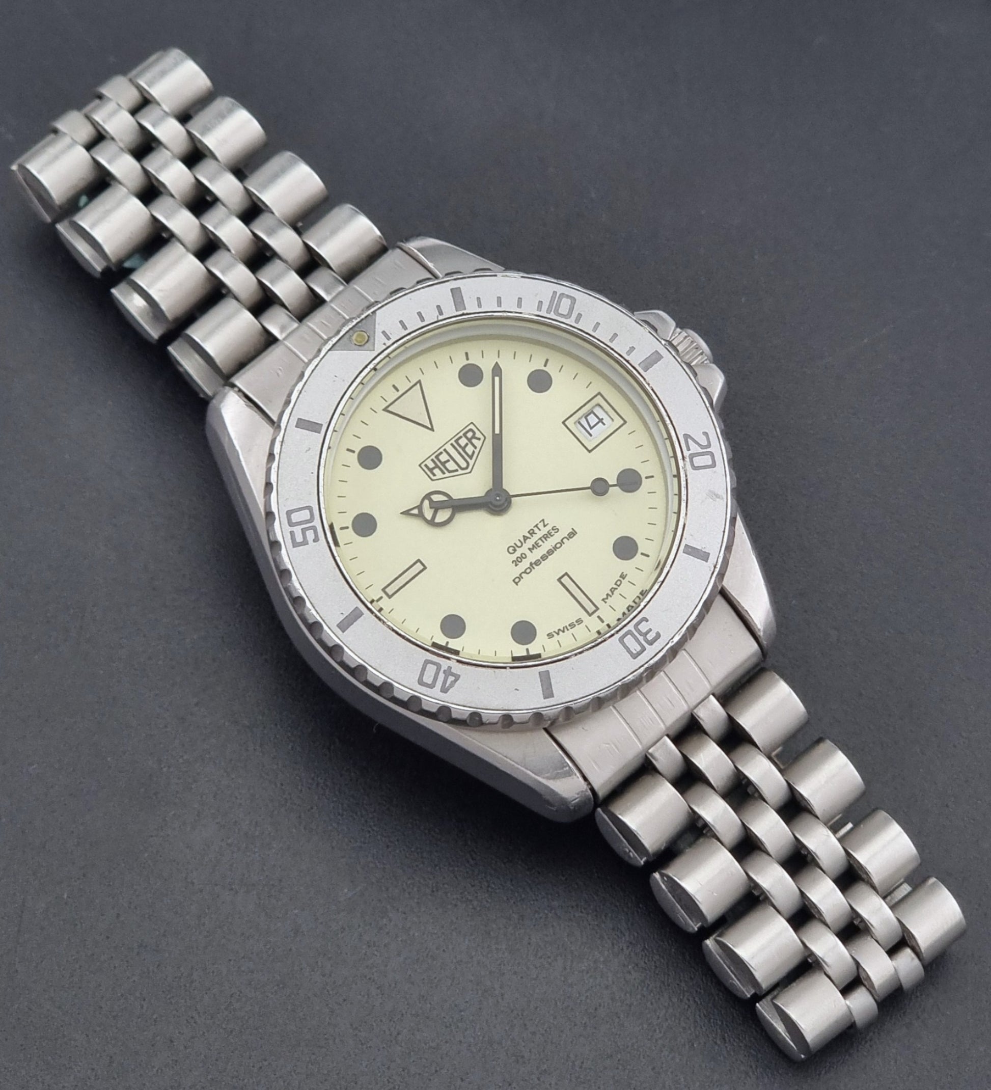 Vintage Heuer Wristwatch Professional Quartz Night Diver 982.113 with a pewter colours pvd coated case on a dark background dial