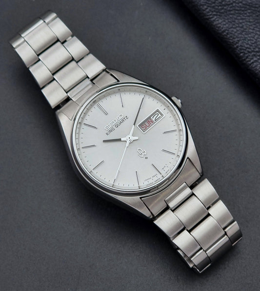 Vintage Seiko King Quartz watch 4823-8110 with a metallic band on a dark background dial