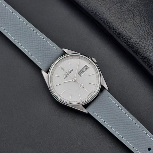 Vintage Seiko King Quartz Wristwatch 9923-7020 Twin Quartz with light grey strap on a dark gray background  dial