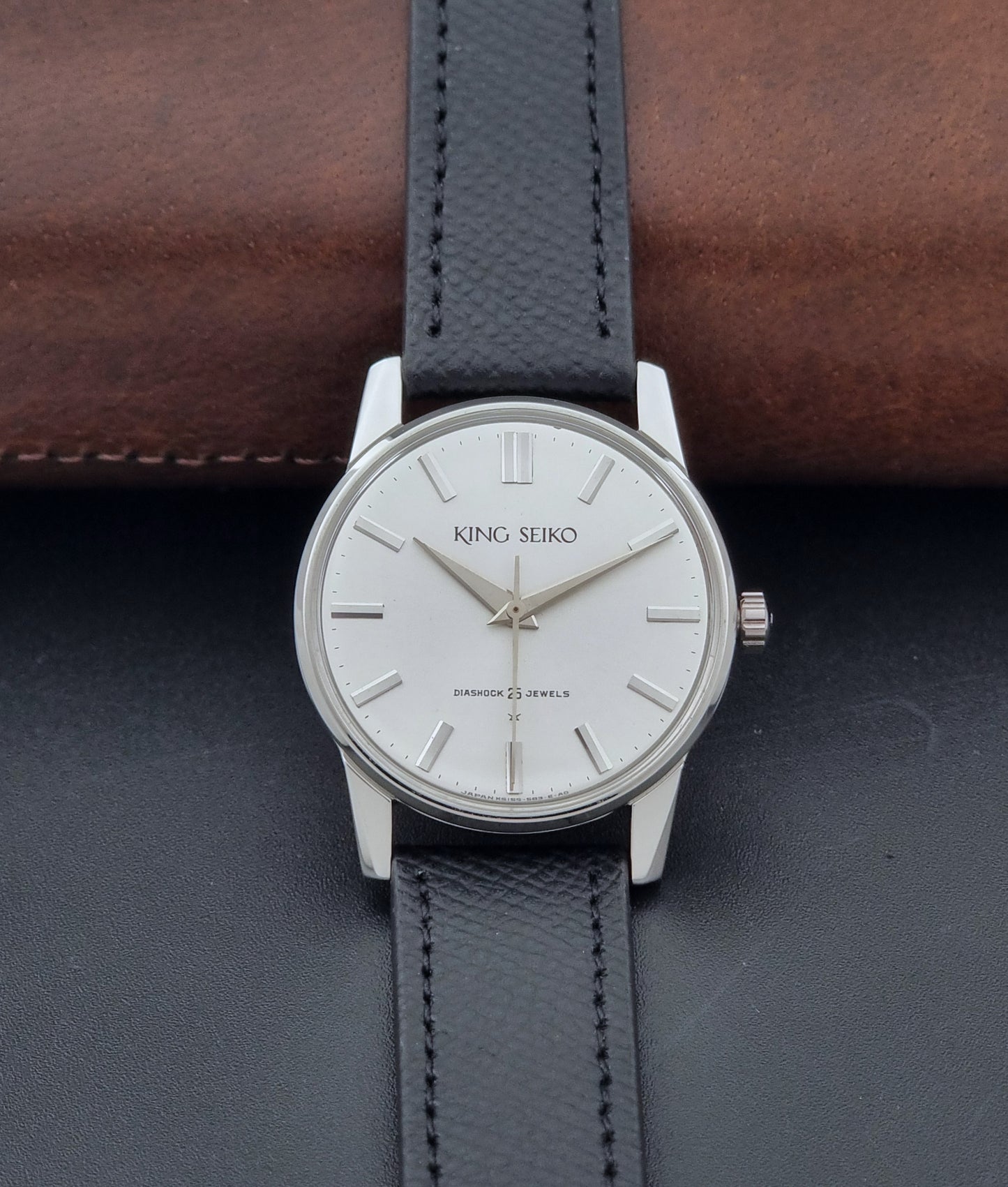 Vintage King Seiko Wristwatch 15034 with a black leather strap on a gray surface dial view