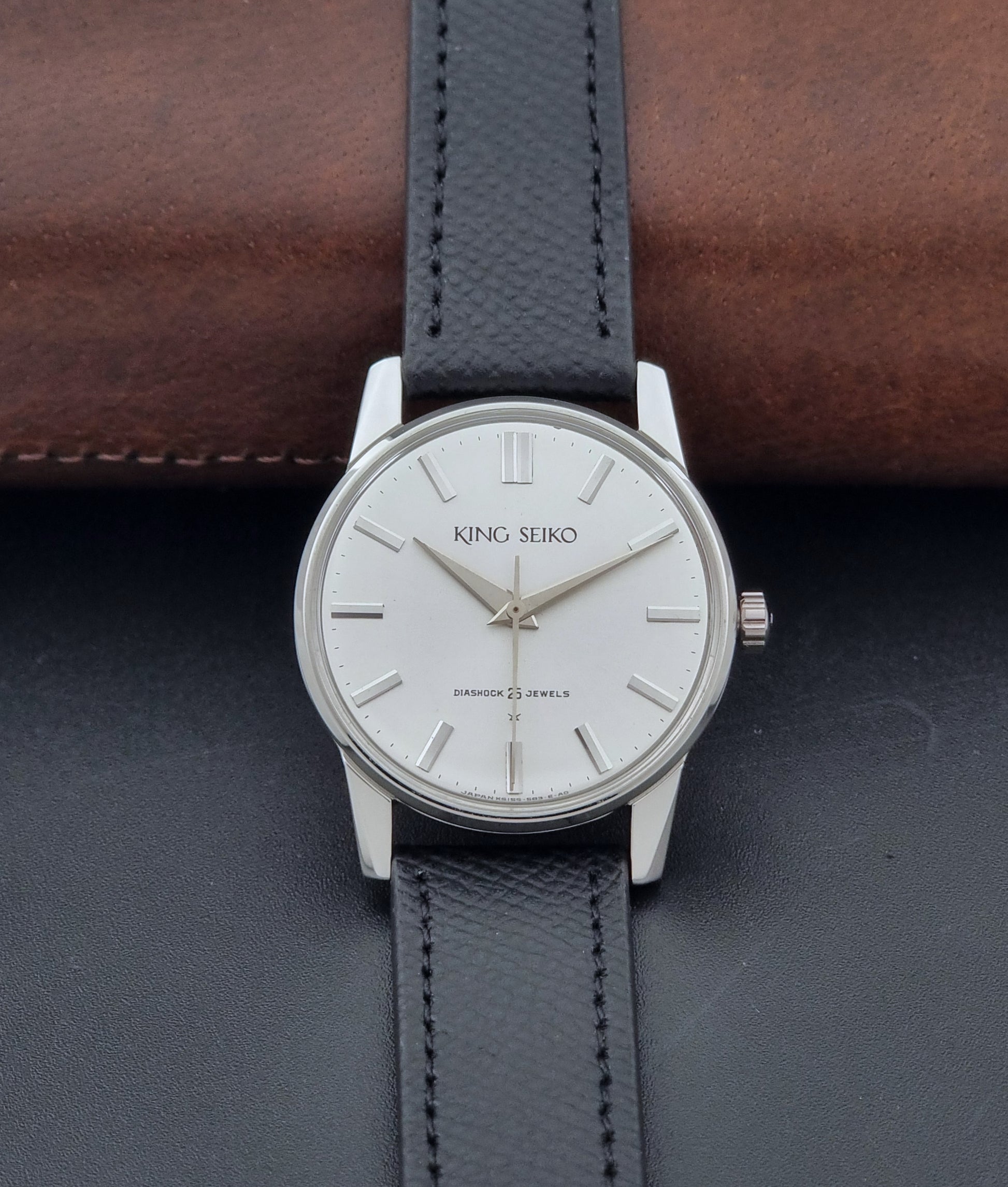 Vintage King Seiko Wristwatch 15034 with a black leather strap on a gray surface dial view
