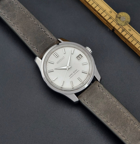 Vintage King Seiko Wristwatch 4402-8000 watch with grey leather strap on a dark surface dial