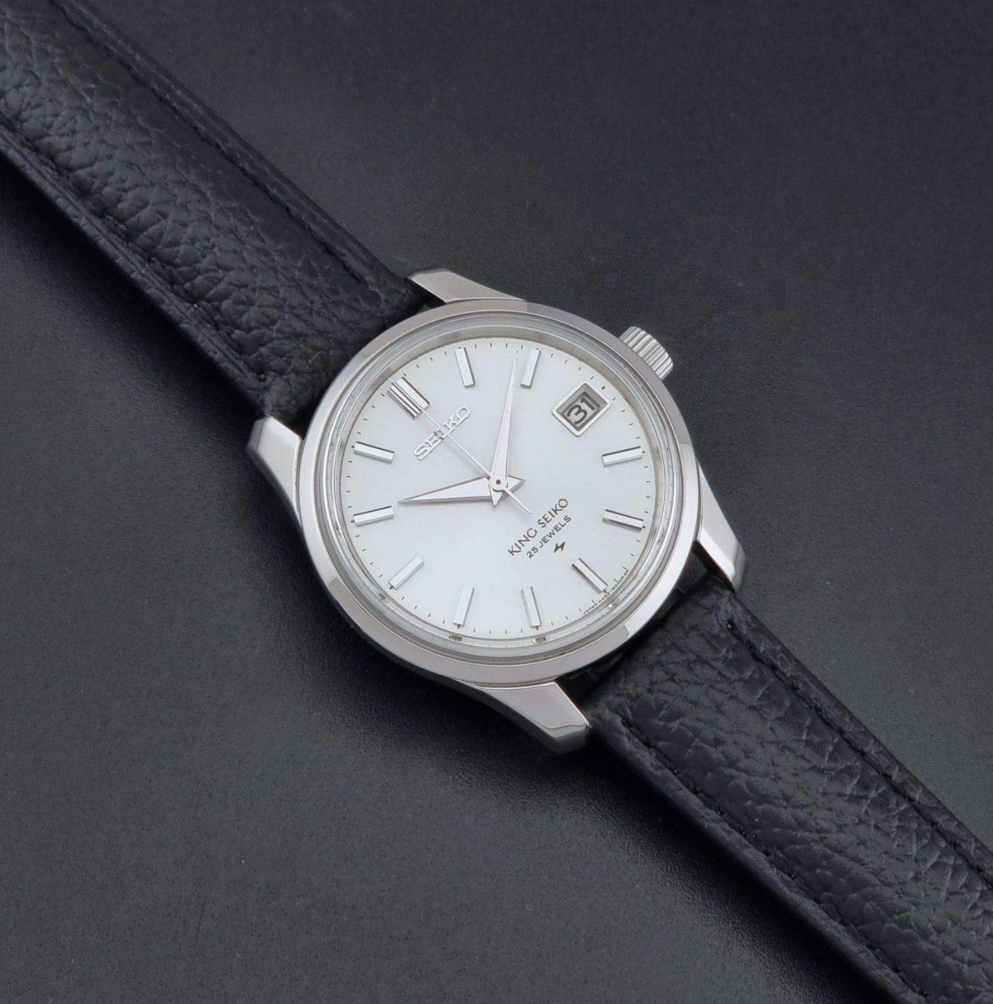 Vintage King Seiko 4402-8000 Wristwatch with a white dial on a dark background dial